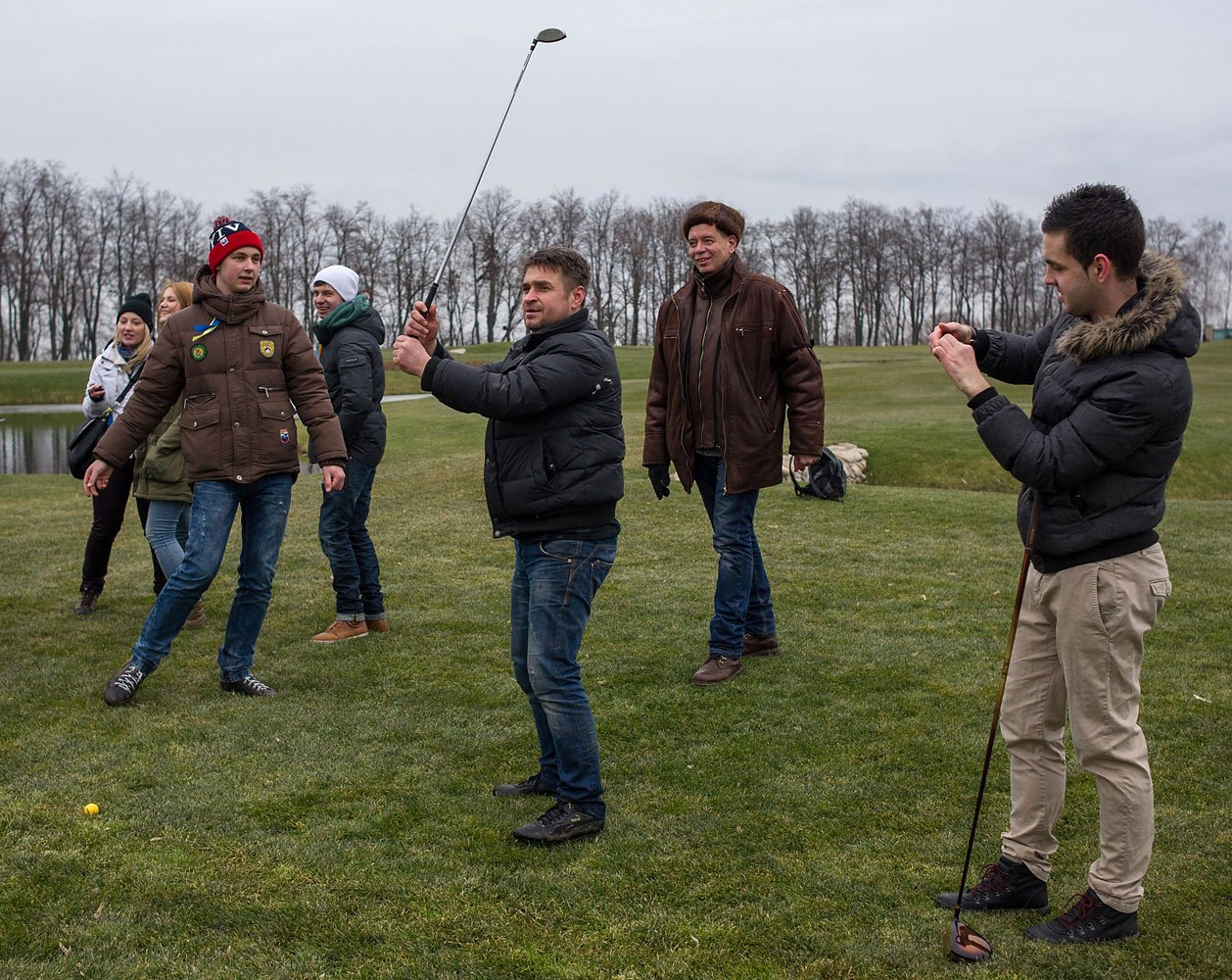 Protesters try to play on a golf course at the Ukrainian President Yanukovych's countryside residence.
