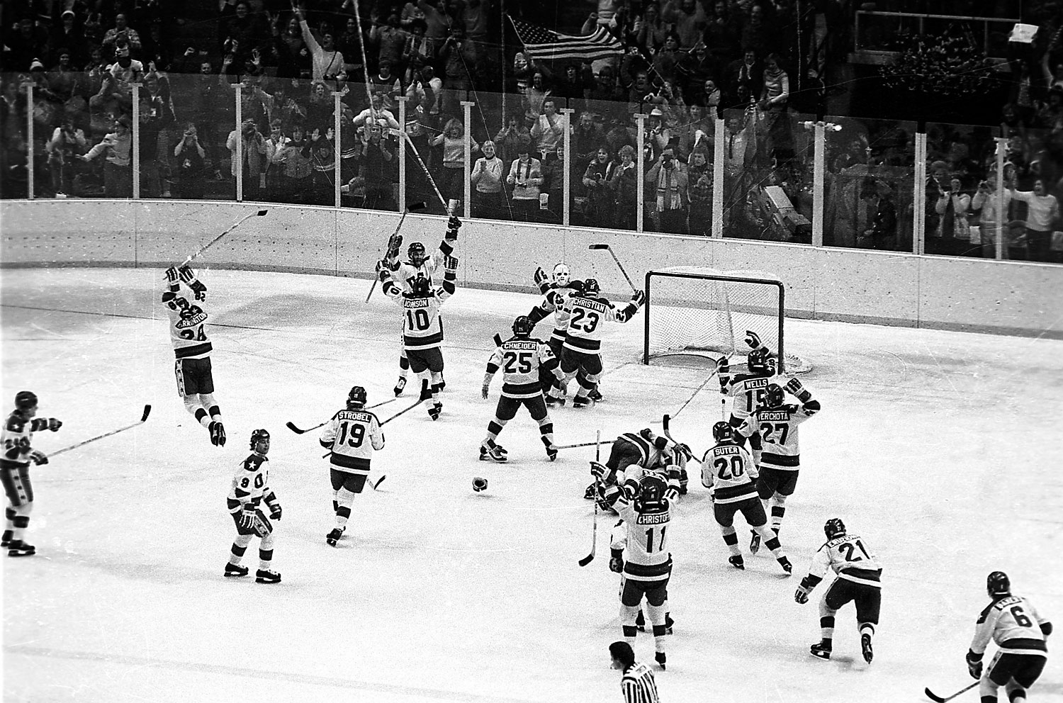 The U.S ice hockey team rushes toward goalie Jim Craig after their upset win over the Soviet Union in the semi-final round of the XIII Winter Olympic Games in Lake Placid, N.Y., Feb. 22, 1980. (AP)