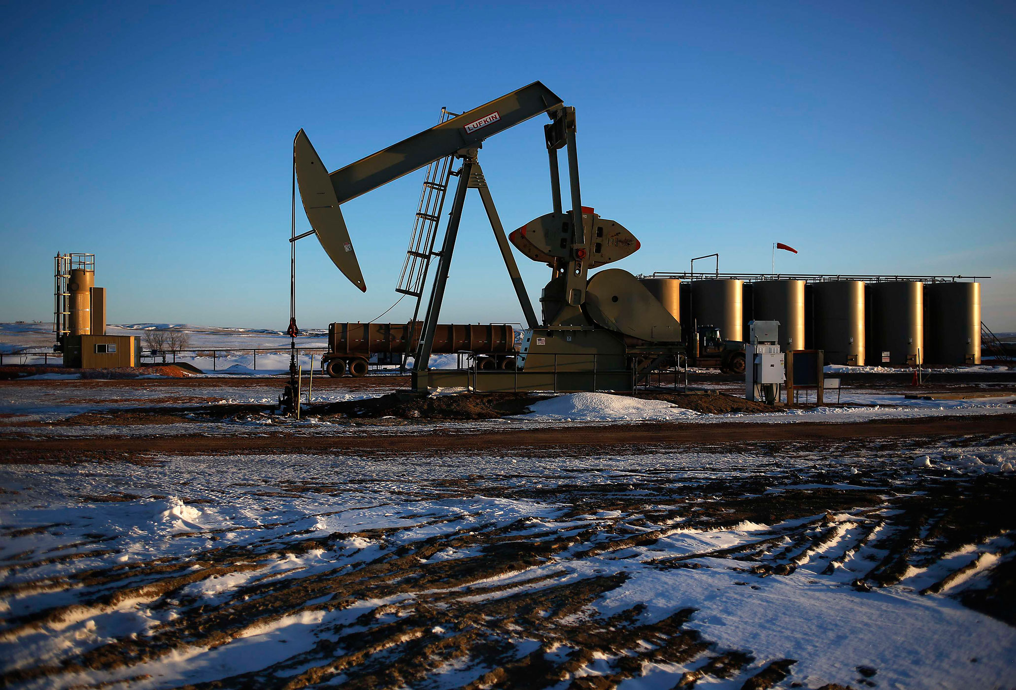 An oil drilling pump site is seen in McKenzie County outside of Williston, North Dakota