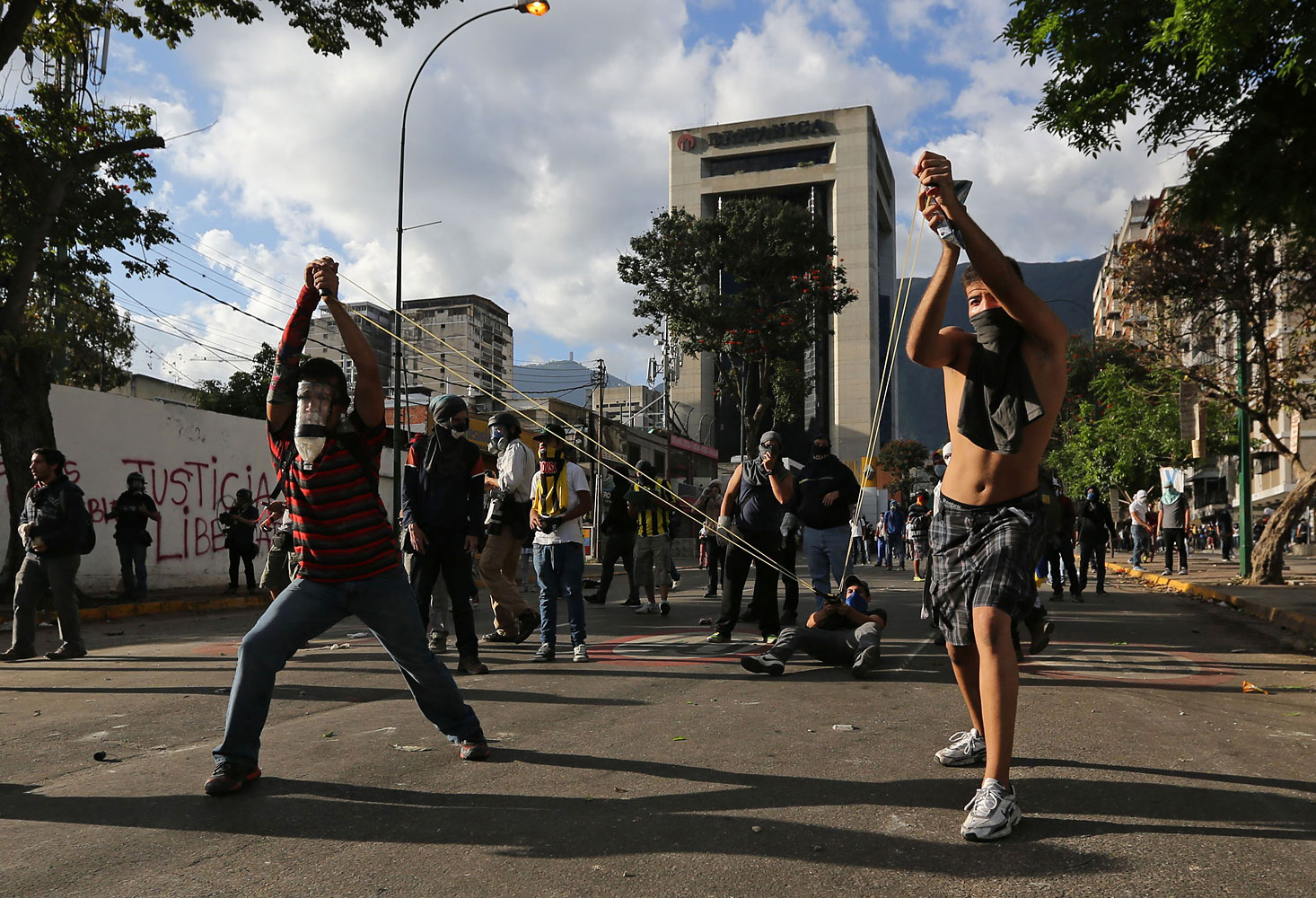 Demonstrators use a giant slingshot to launch stones at Bolivarian National Guards during clashes in Caracas, March 2, 2014.