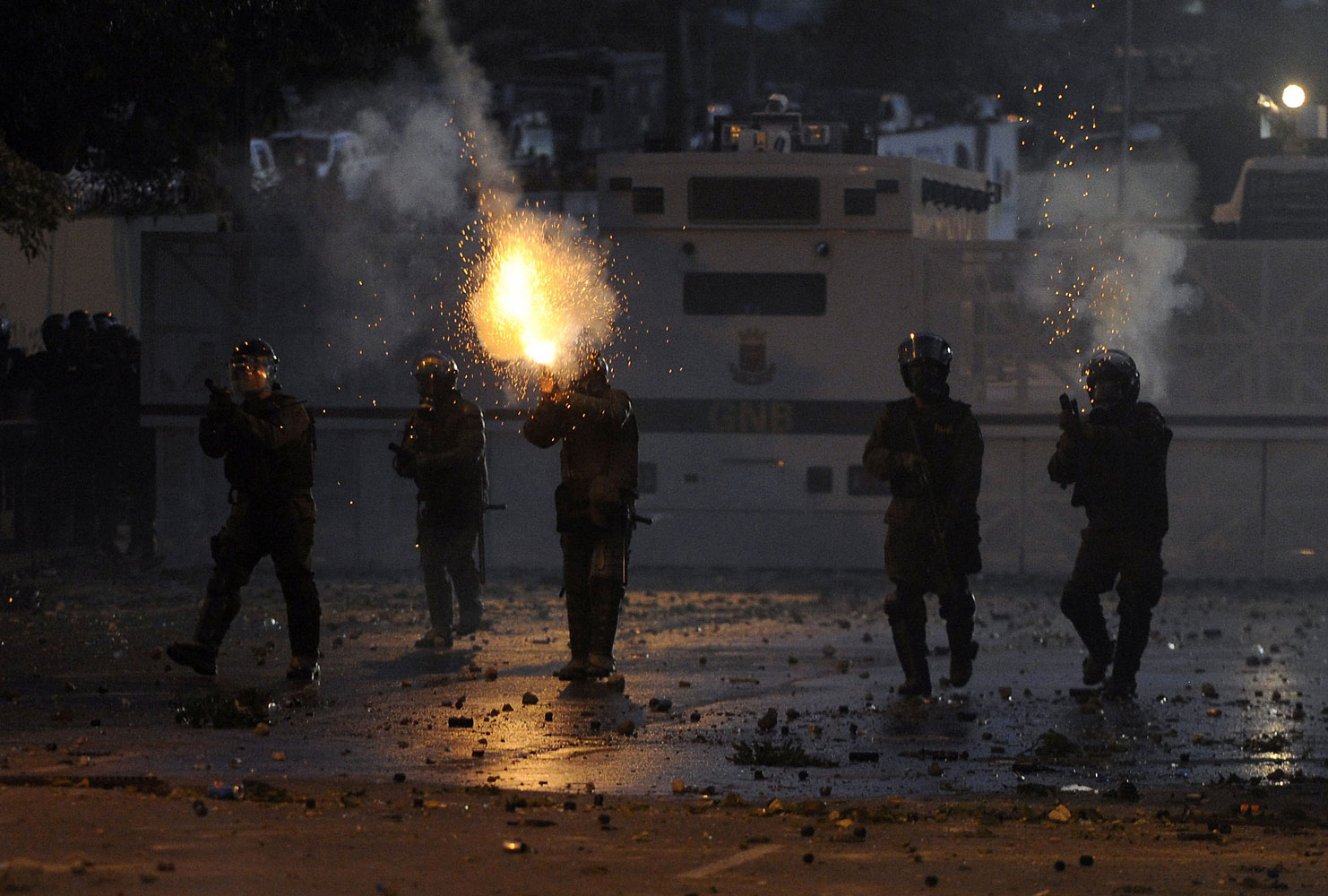 Members of the National Guard shoot during a protest against the government of Venezuelan President Nicolas Maduro, in Caracas on March 2, 2014.