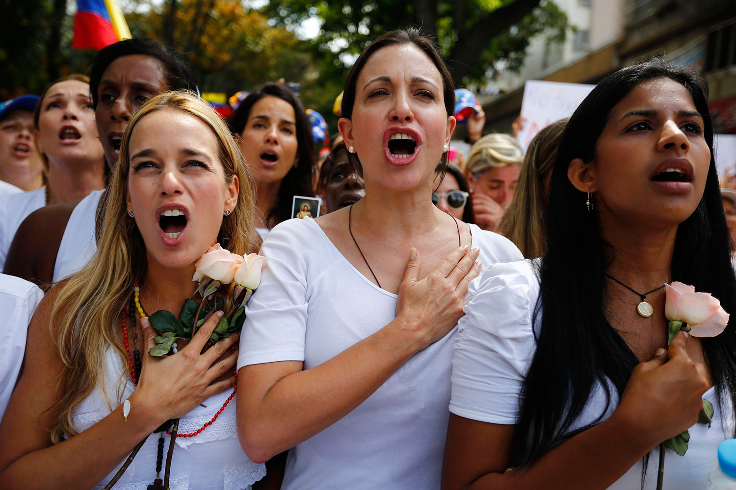 Lilian Tintori, wife of jailed opposition leader Leopoldo Lopez, and opposition deputy Maria Corina Machado take part in a women's rally against Nicolas Maduro's government in Caracas Feb. 26, 2014.