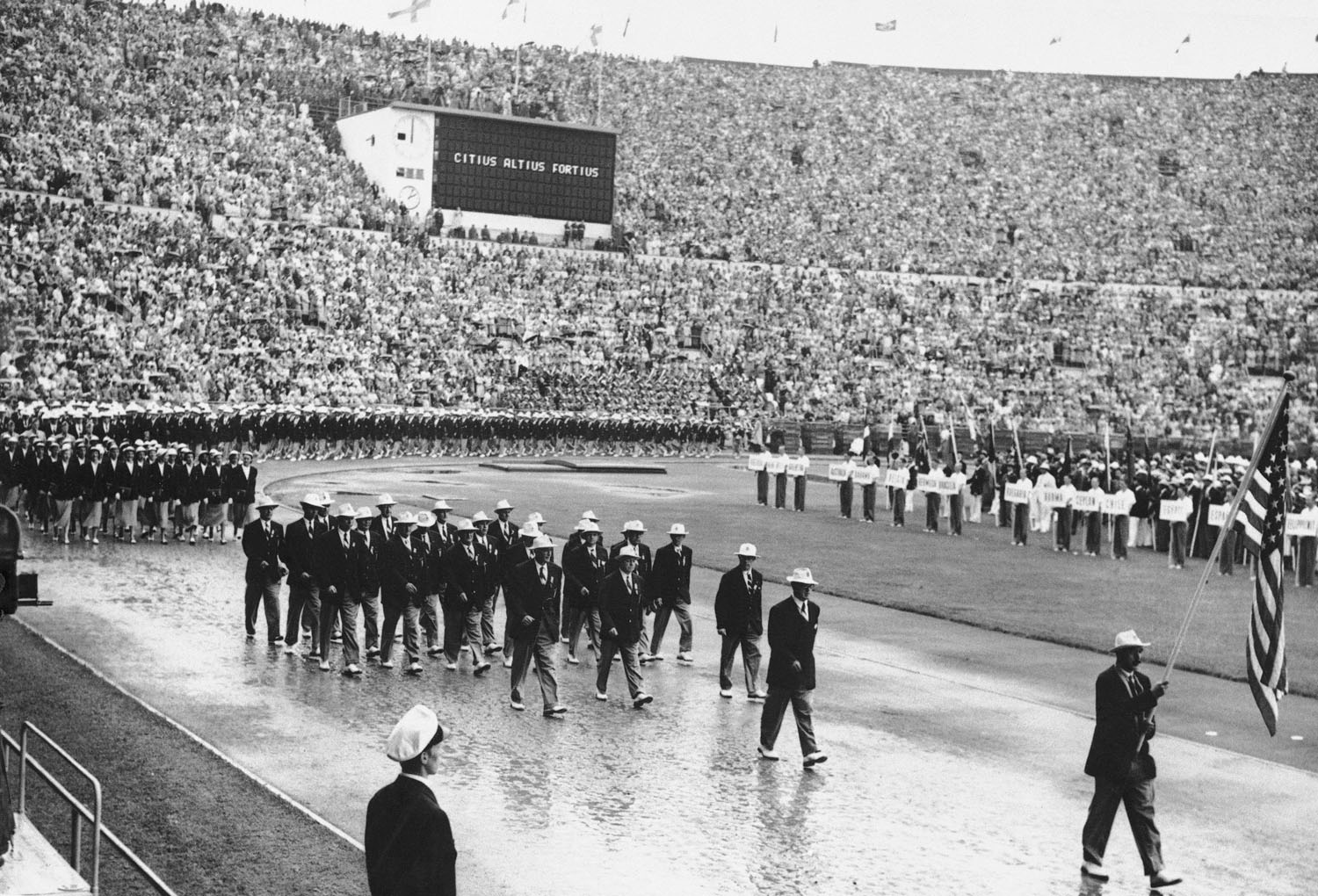 Bobsledder Jim Bickford, carries the American flag during the opening ceremonies for the 1952 games at Oslo.