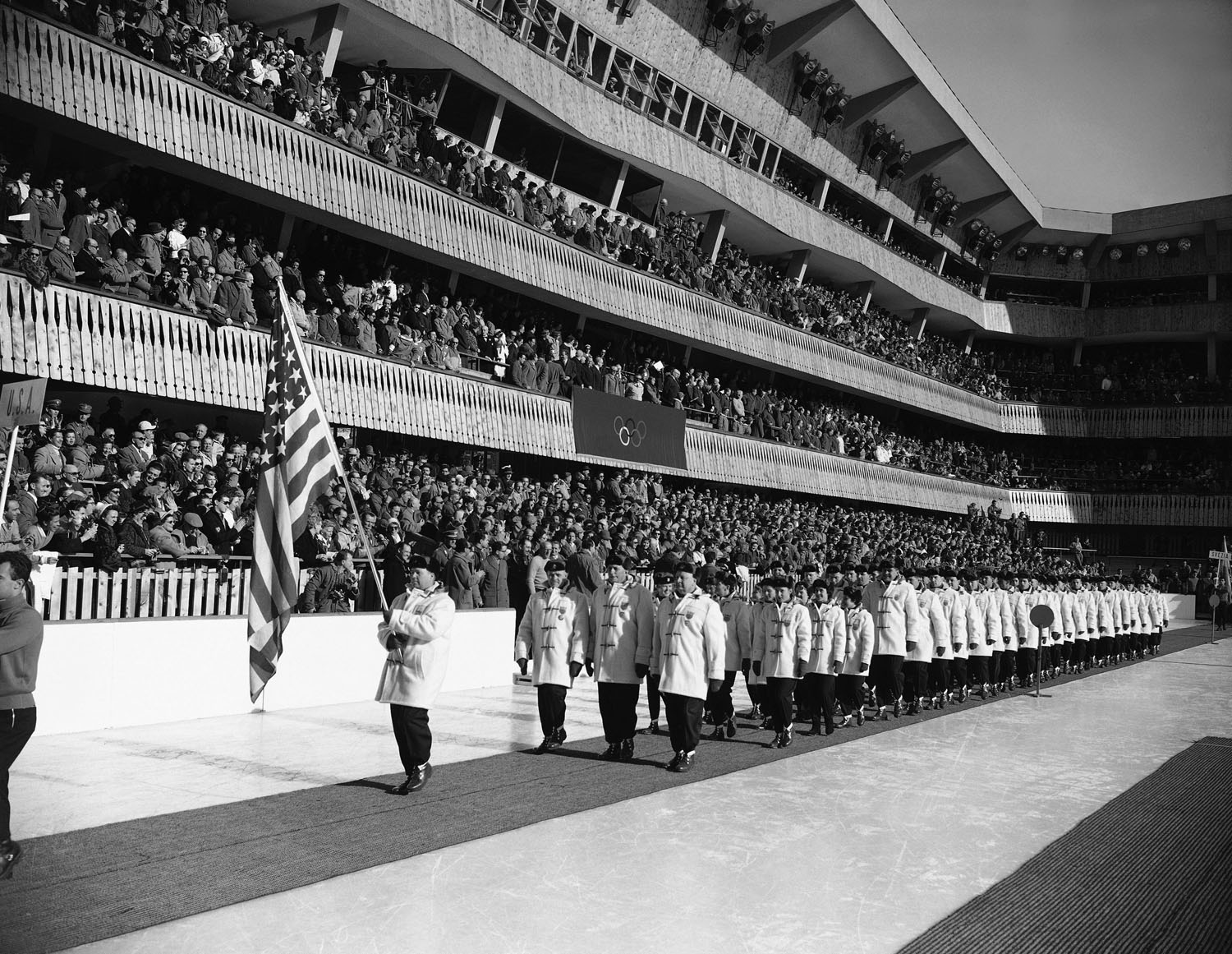 Jim Bickford, carries the U.S. flag again during the opening ceremonies for the 1956 Winter Olympic Games in Cortina D'Ampezzo, Italy.