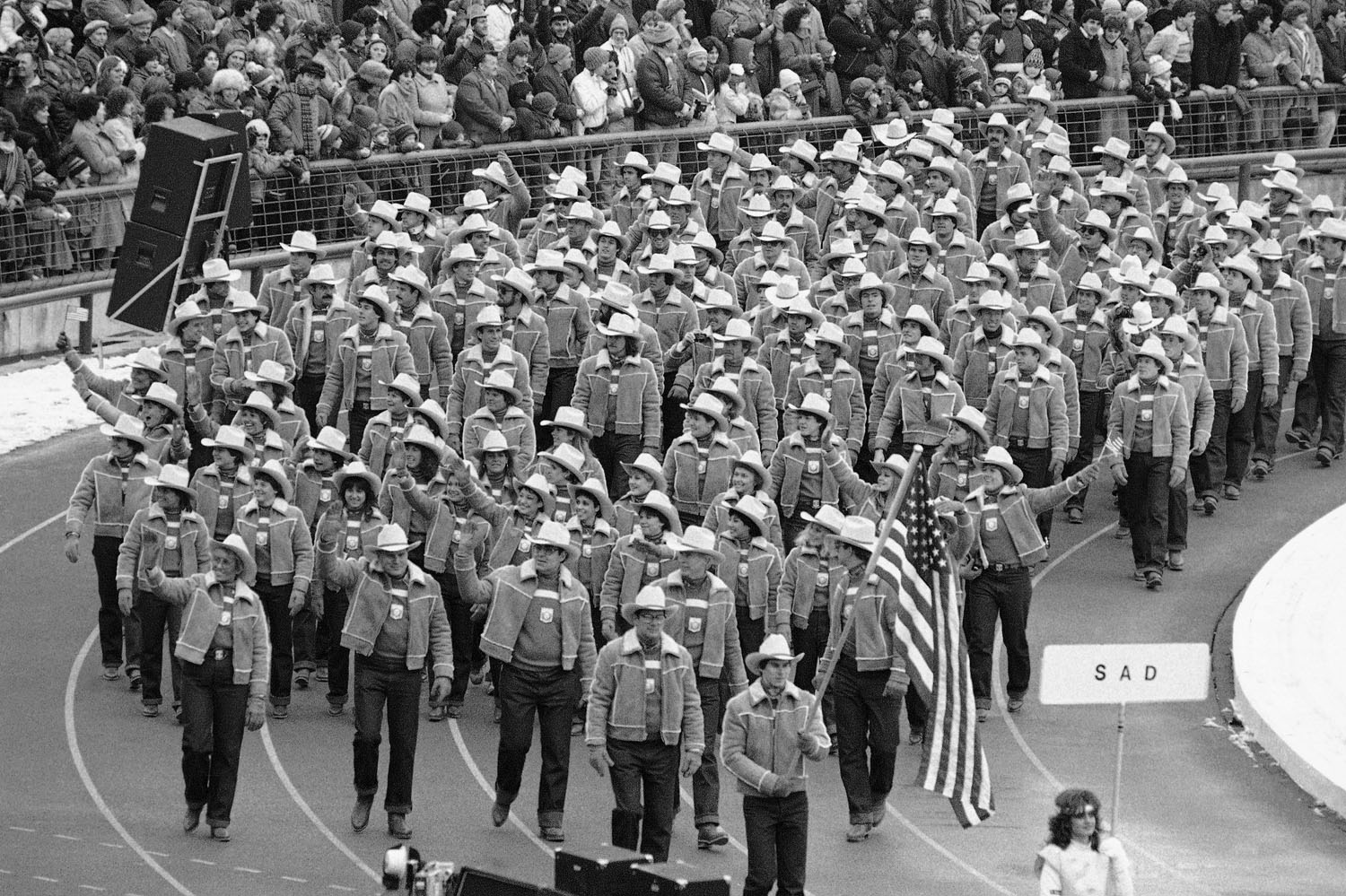 Luger Frank Masley carries the U.S. flag as he and his teammates march during the opening ceremonies of the 14th Winter Olympics in Sarajevo,Yugoslavia, Feb. 8, 1984.