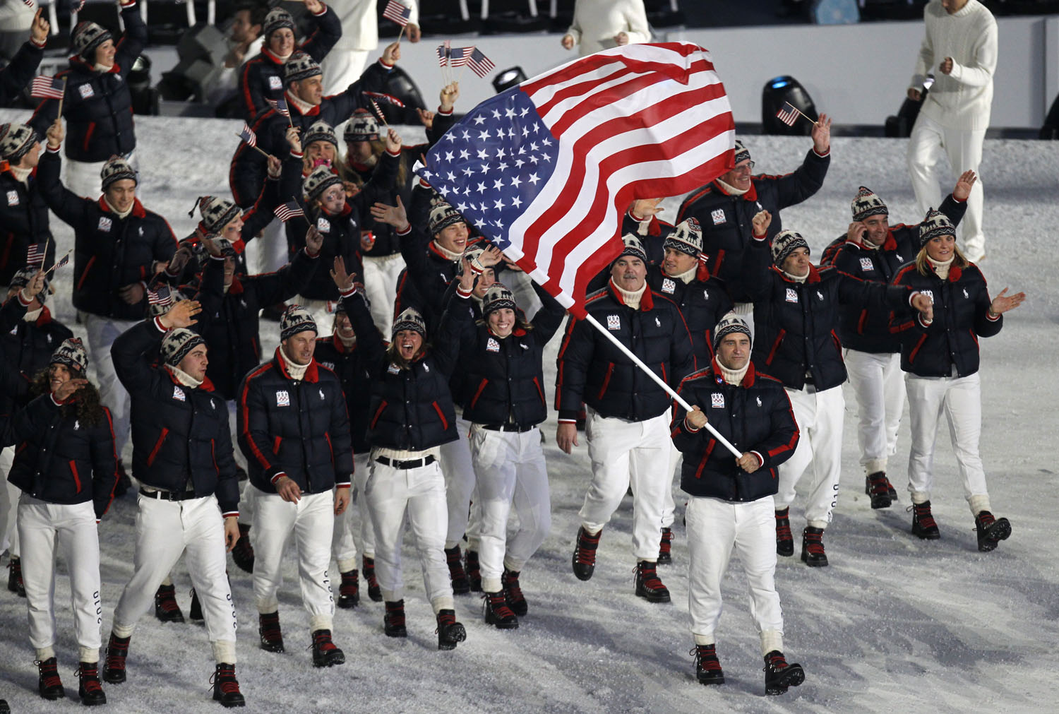 Luger Mark Grimmette bears the American flag and leads his delegation during the opening ceremony of the Vancouver Winter Olympics, Feb. 12, 2010.