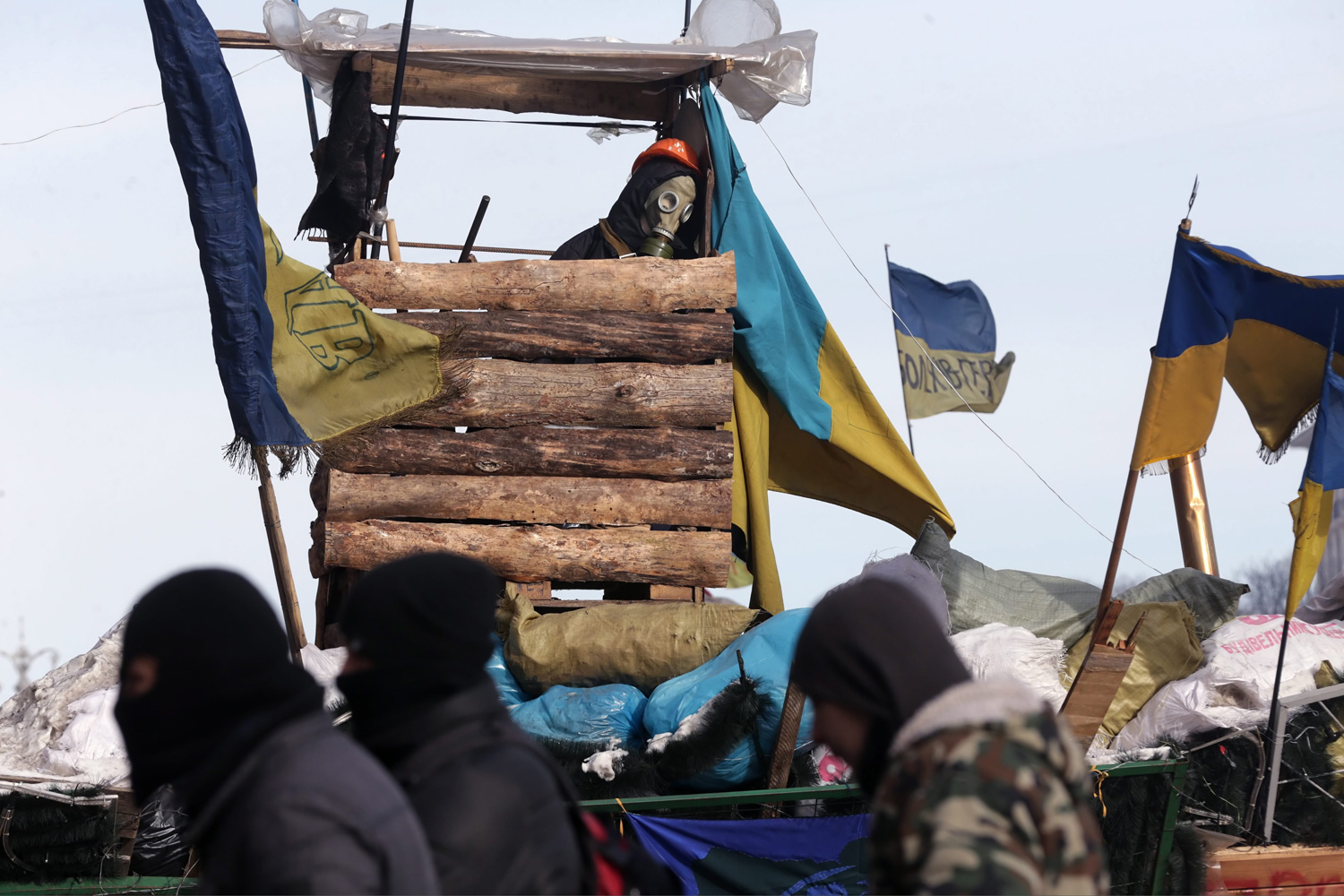 Feb. 1, 2014. Protesters stand guard near one of the barricade during the continuing protest in Kiev, Ukraine.