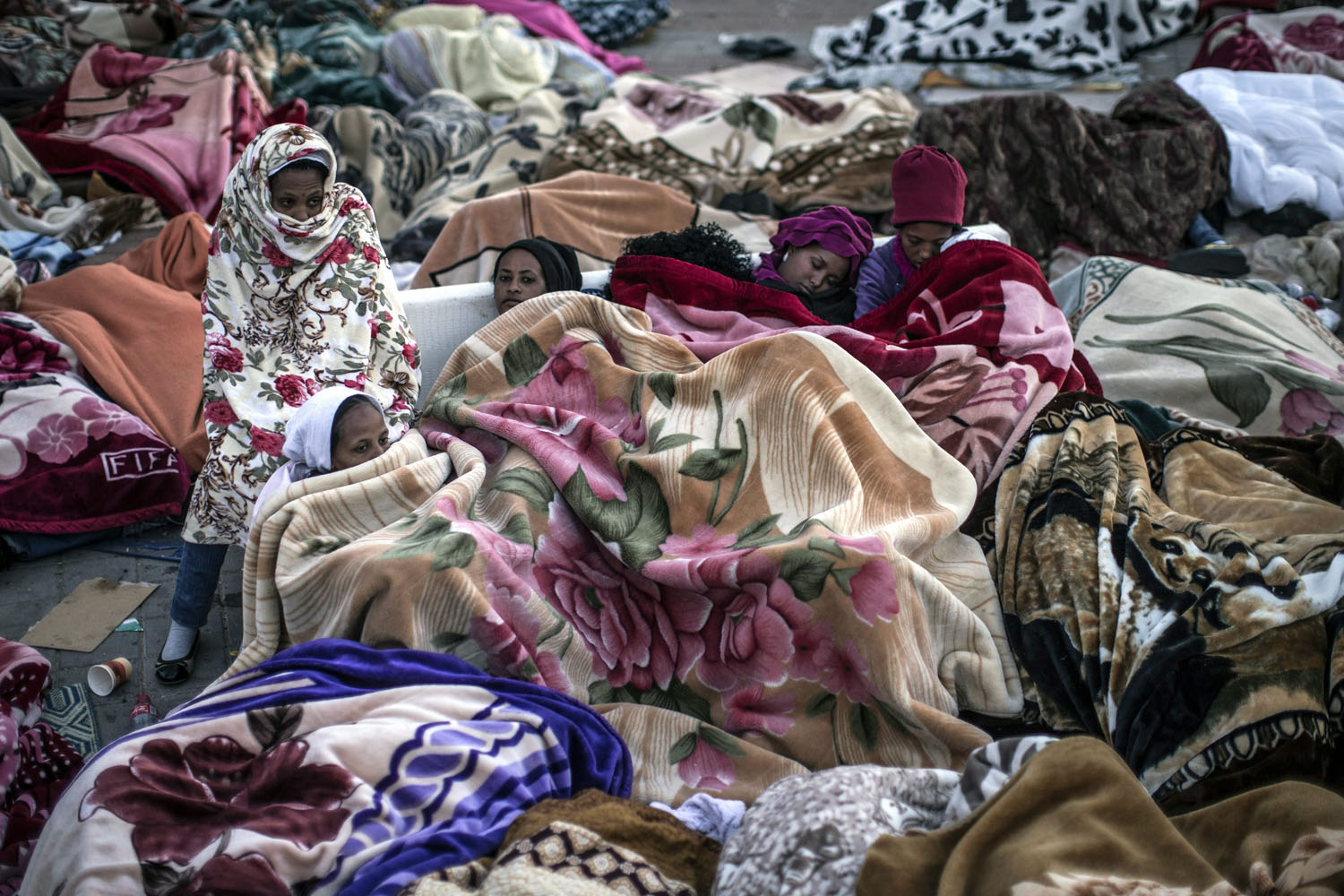 Feb. 5, 2014. Female African asylum seekers sleep on a sofa in Levinski Park, southern Tel Aviv, Israel.