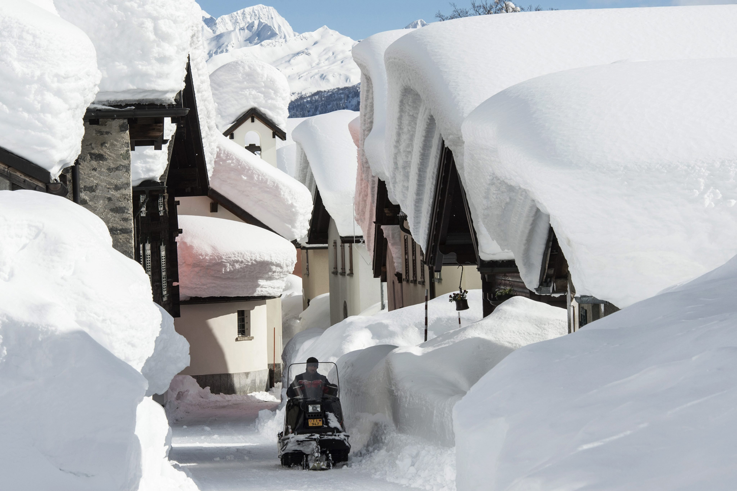 Feb. 9, 2014. Snow masses pile up on the rooftops of the village of Bedretto, Switzerland.