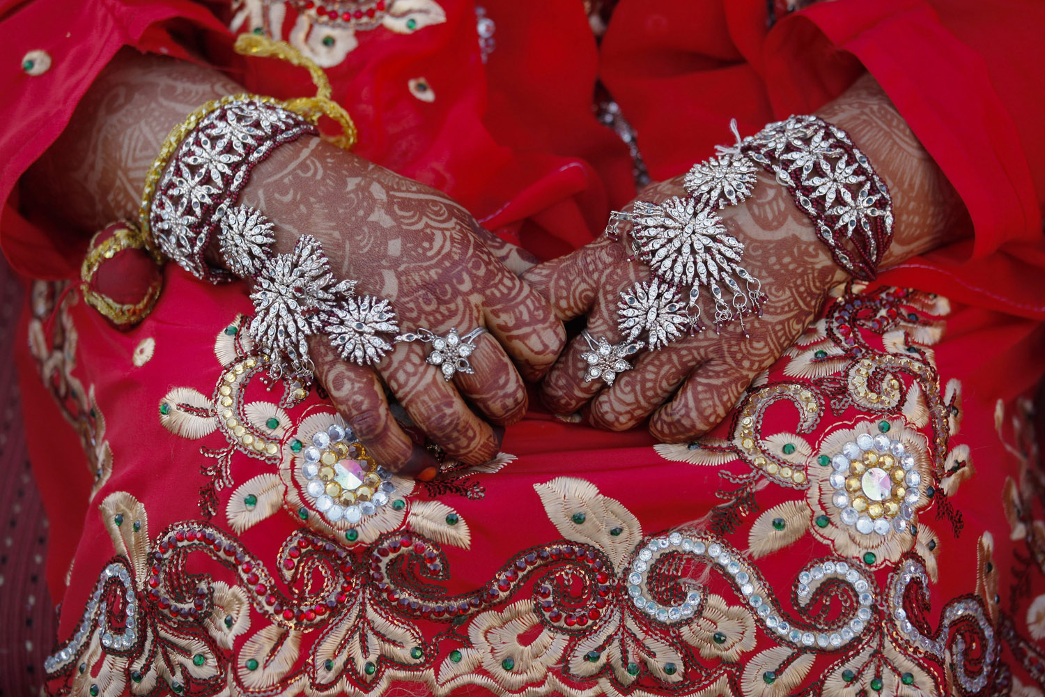 Feb. 9, 2014. The hands of a Indian Muslim bride dressed in traditional marriage attire during a mass marriage ceremony in Mumbai, India.