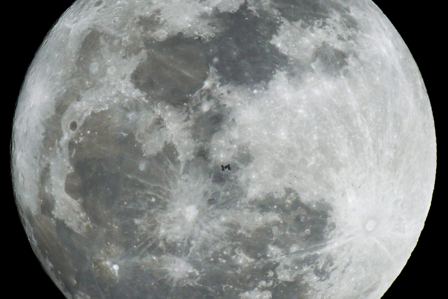 International Space Station flies in front of the Moon