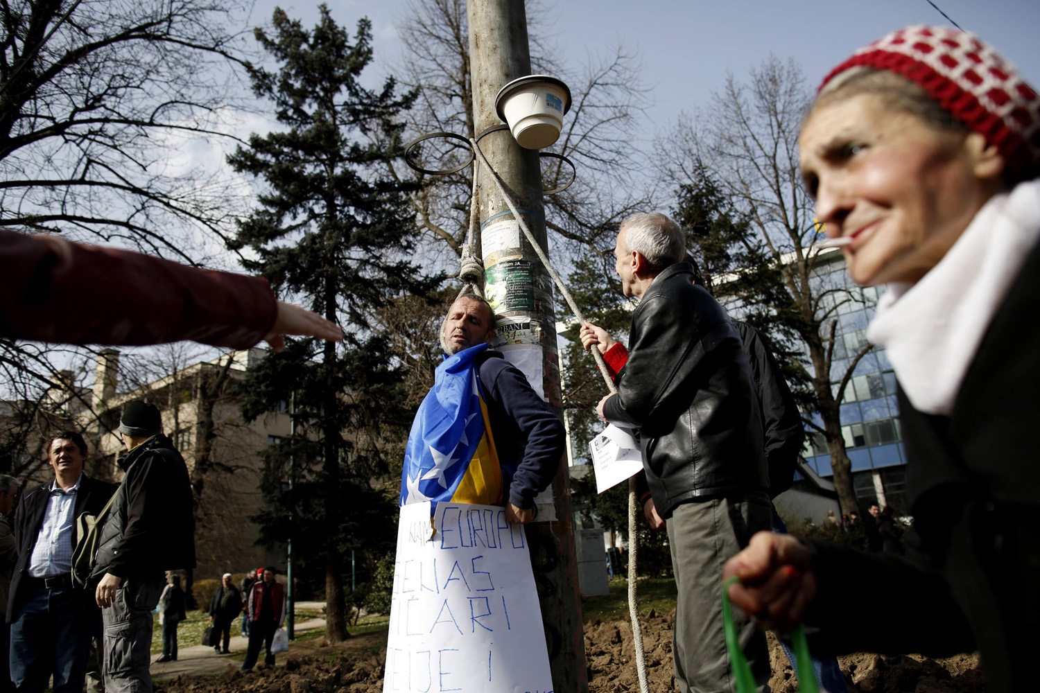 Anti-government protesters simulate an execution scene during a protest in Sarajevo