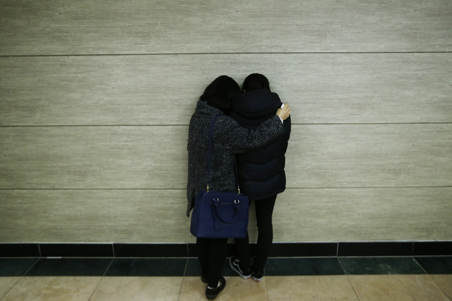Relatives of victims who were killed when a resort building collapsed, comfort each other at a group memorial altar in Gyeongju