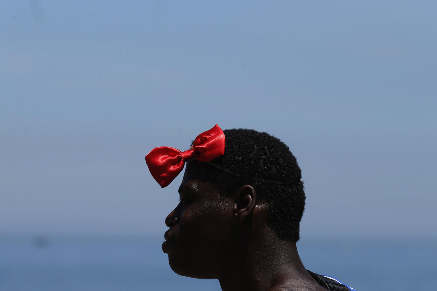 Man wears bow tie as he takes part in the annual block party known as the "Banda de Ipanema" during pre-carnival festivities on Ipanema beach in Rio de Janeiro