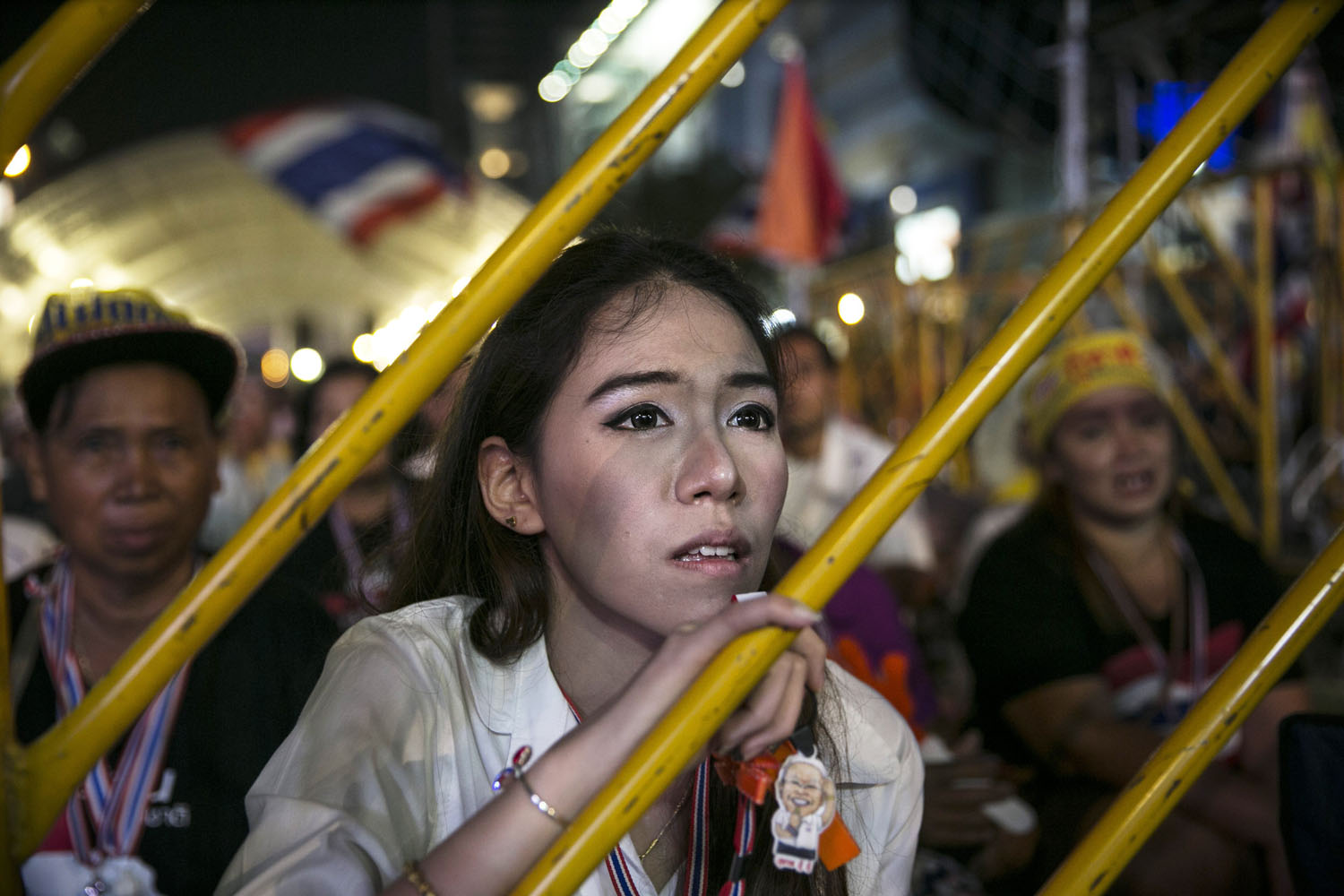 Feb. 3, 2014. An anti-government protestor listens as leader Suthep Thaugsuban speaks about the elections during his daily speech in Bangkok.