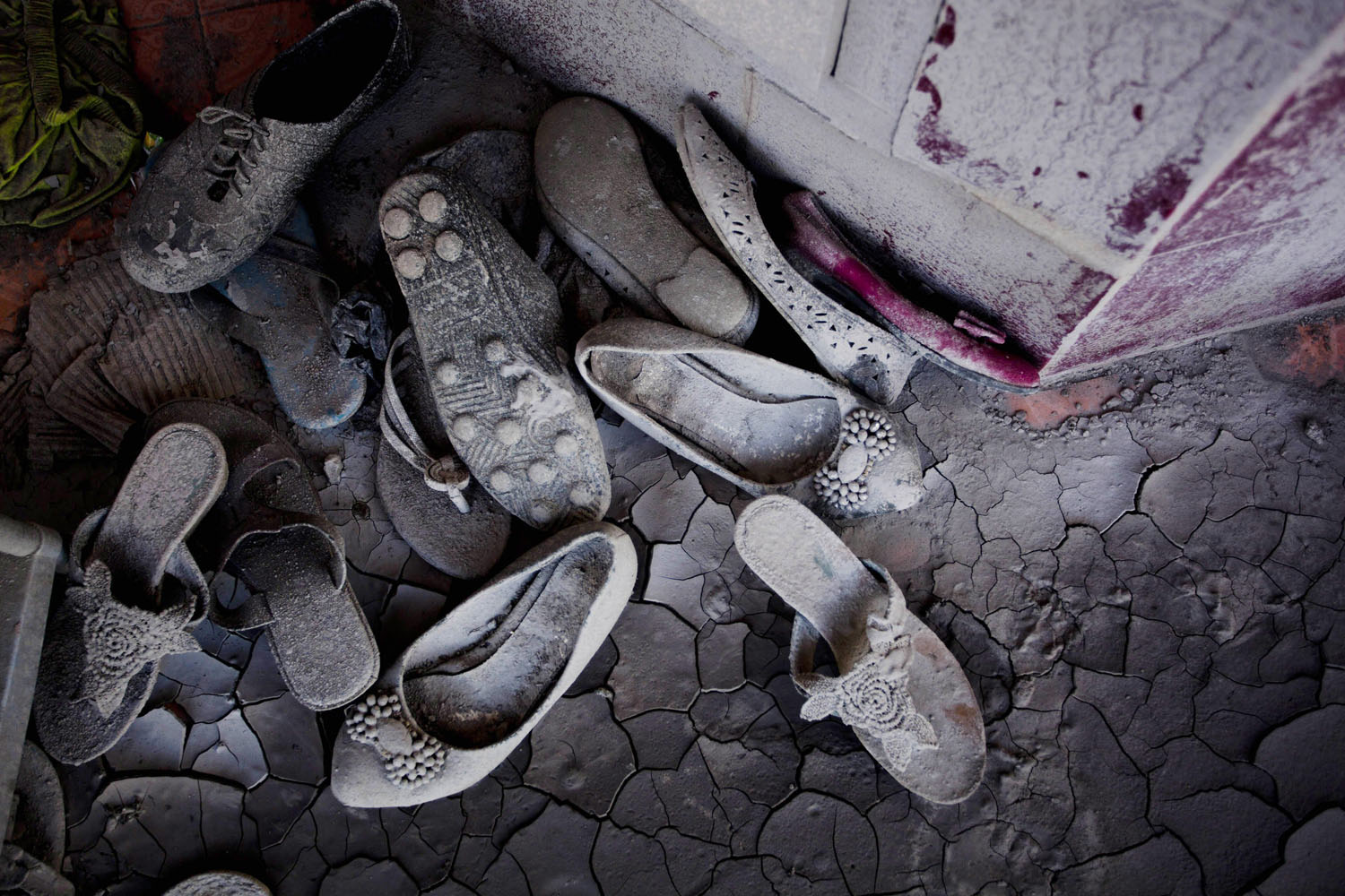 Feb. 5, 2014. Shoes sits covered in ash in front of abandoned house from the erupting Mount Sinabung February 05, 2014 in Sigarang Garang village, Karo District, North Sumatra, Indonesia.