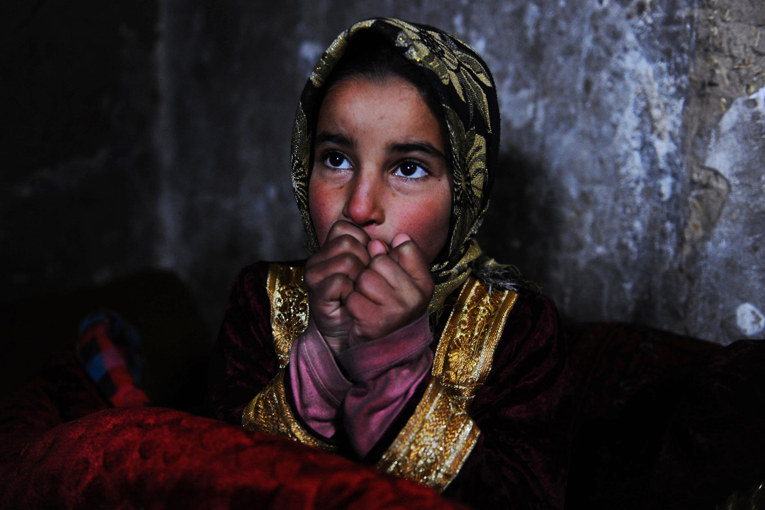 Feb. 7, 2014. An Afghan child warms herself near a traditional  sandali  stove at her family's home in Herat, Afghanistan.