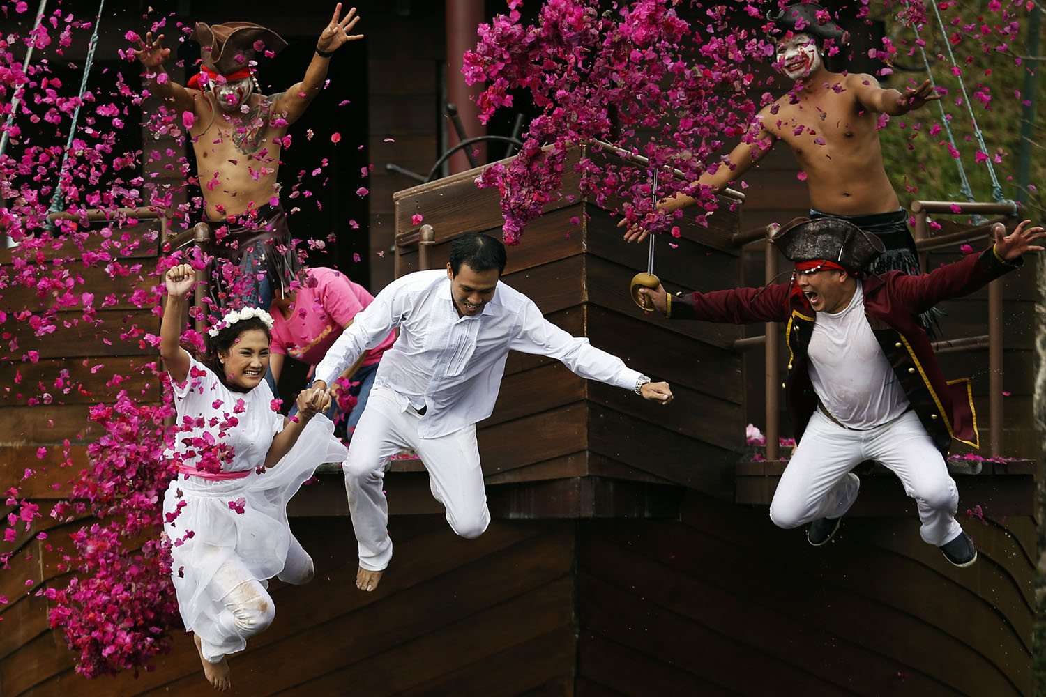 Feb. 13, 2014. Groom Roongroj Walailuk and bride Vina Wichan jump into the pond as they are chased by men dressed as pirates during a wedding ceremony ahead of Valentine's Day in Prachin Buri province, east of Bangkok.