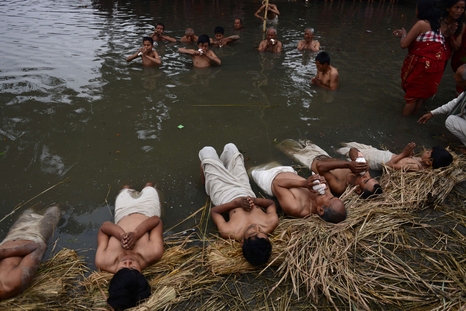 Feb. 14, 2014. Nepalese Hindu devotees perform a bathing ritual on the final day of the month-long Swasthani Festival near the Hanumante River at Bhaktapur, on the outskirts of Kathmandu, Nepal.
