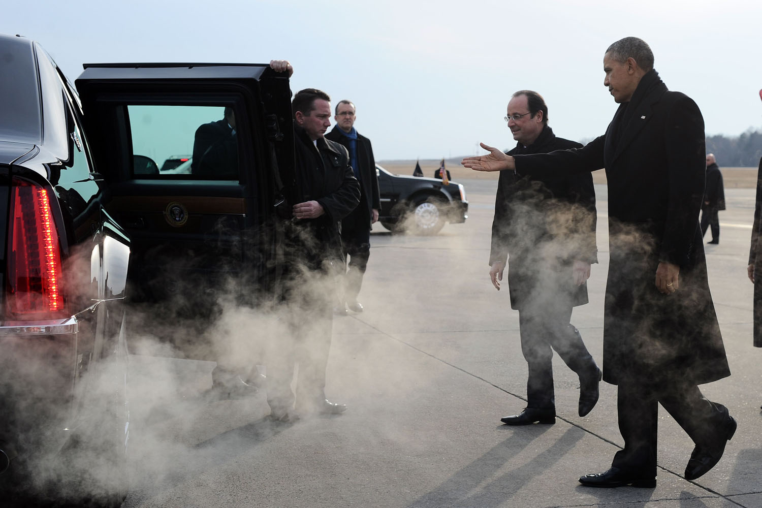 Feb. 10, 2014. U.S. President Barack Obama shows way to his French counterpart Francois Hollande after disembarking from Air Force One at Charlottesville Albemarle Airport in Charlottesville, Virginia.