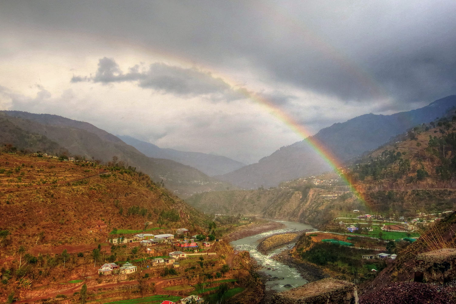 Mar. 4, 2014. The 'end of a rainbow' appears to touch the ground in Muzaffarabad, the capital of Pakistani administered Kashmir.