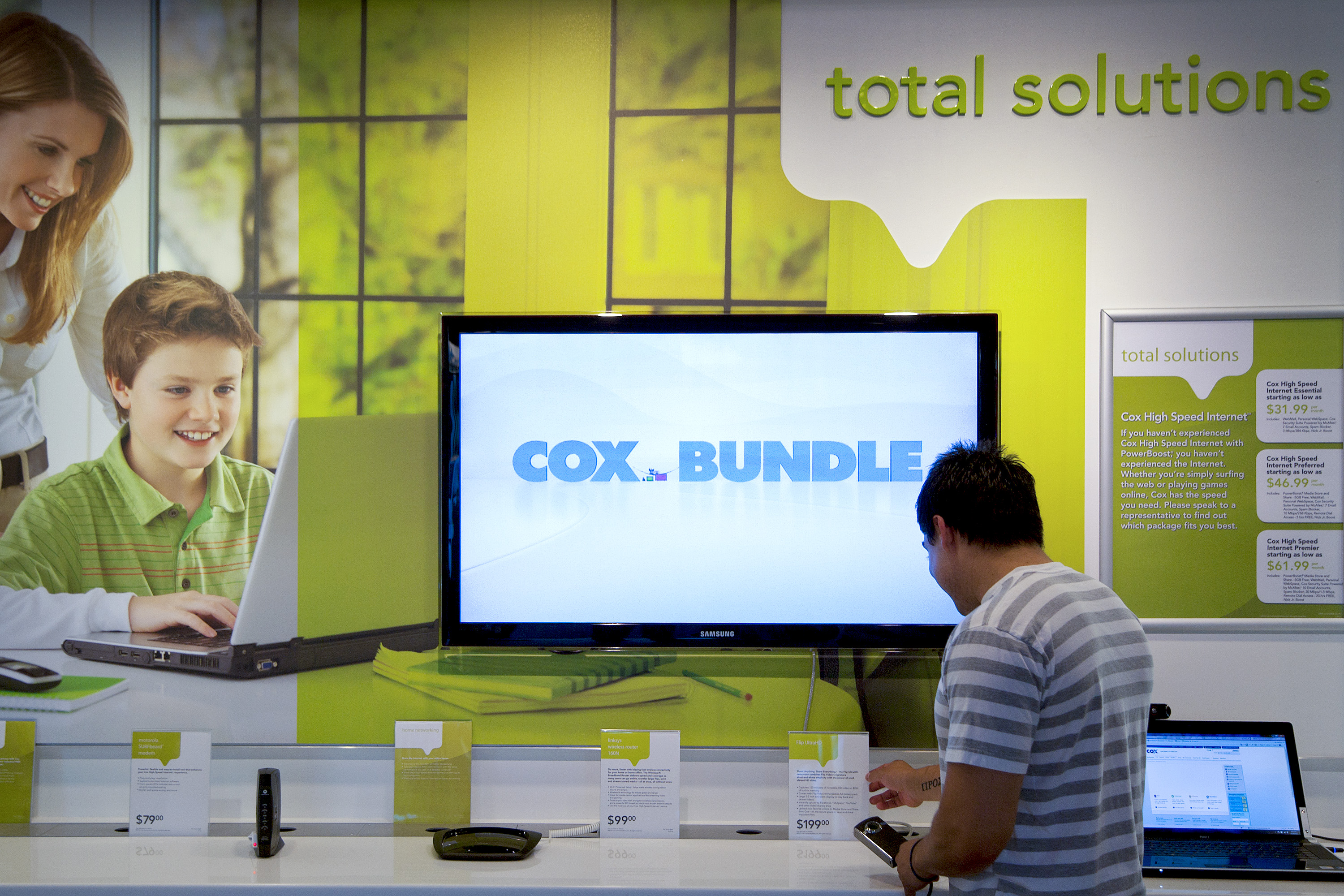 A customer at the Cox Solutions Store in Lake Forest, CA looks over some equipment in the bundled services department. (Bloomberg&mdash;Bloomberg via Getty Images)