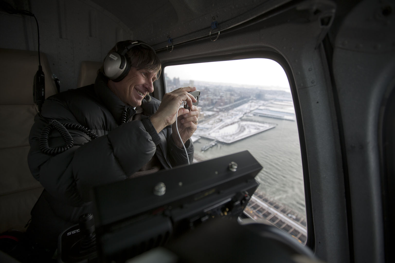 Aerial cinematographer Doug Holgate snaps a photo with his iPHone while flying over the Brooklyn Bridge