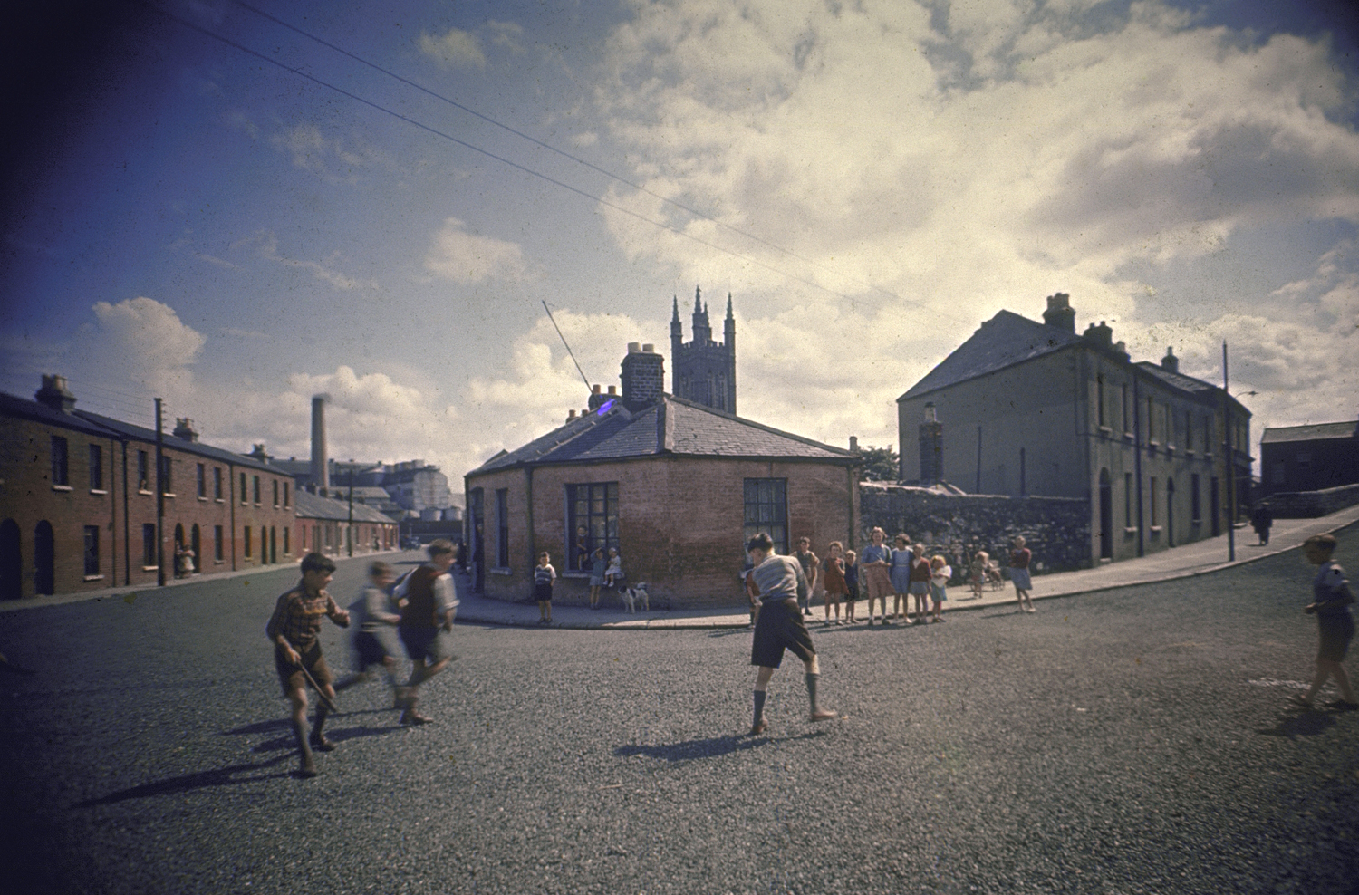 On Abercorn Road the house where O'Casey lived still stands—No. 18, second house in street at right. The boys play hurley, similar to hockey, which O'Casey too played 60 years ago