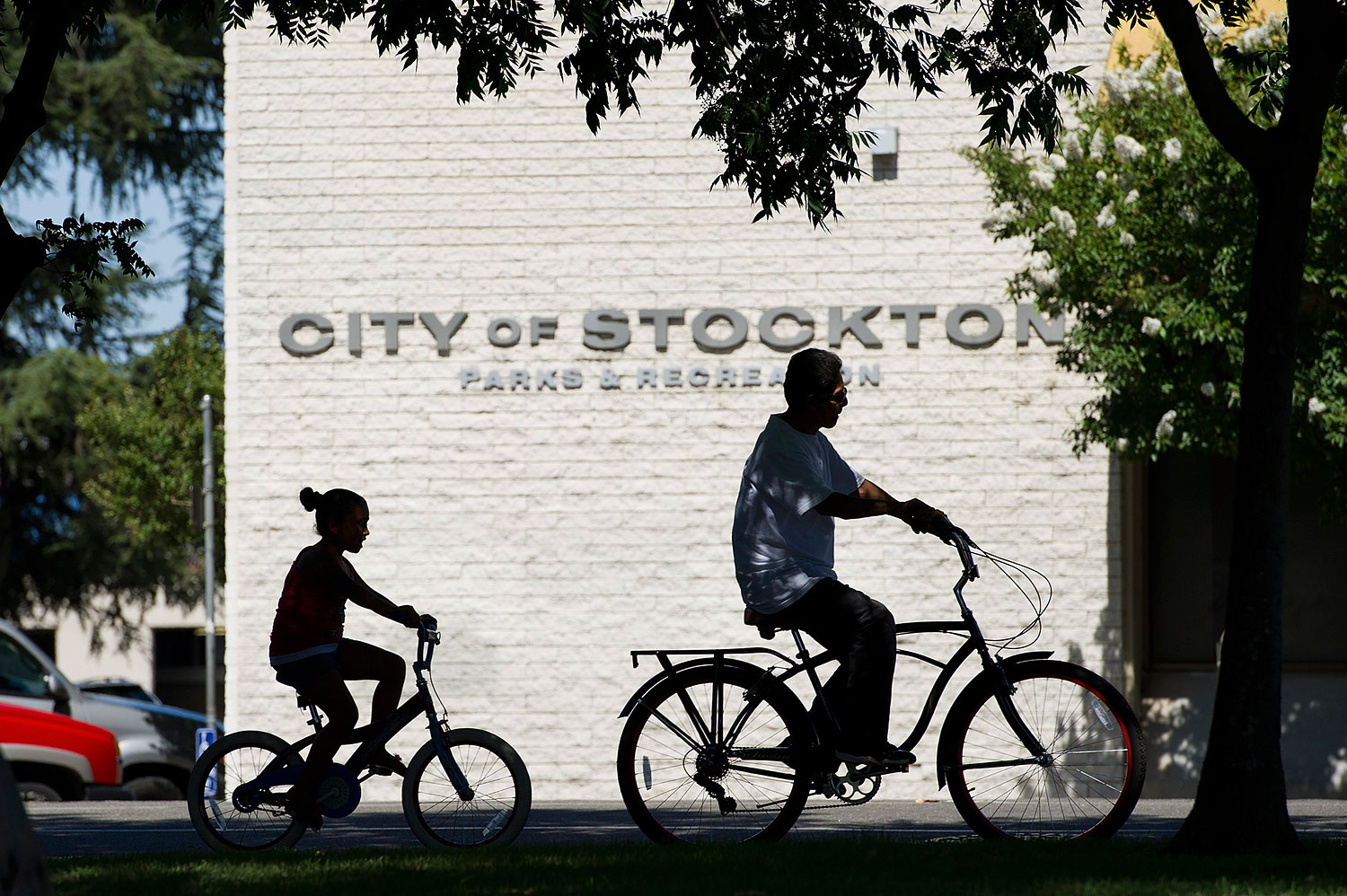 Pedestrians ride their bicycles along the street in Stockton, California, U.S., on June 14, 2012. (David Paul Morris—Bloomberg/Getty Images)
