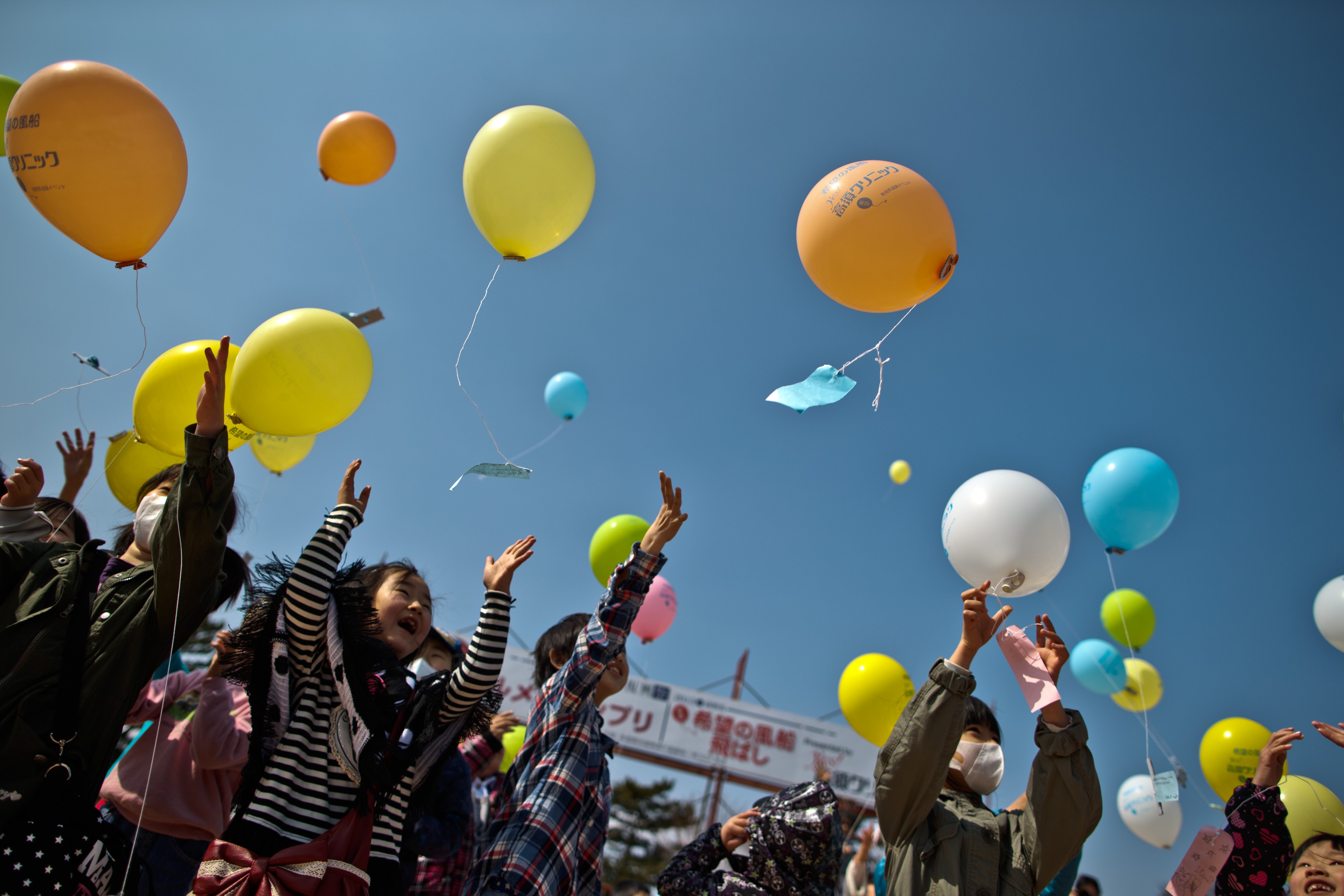 MINAMISOMA, JAPAN - MARCH 10:  Children float balloons and pay their respects to victims during the second anniversary commemoration of the earthquake and tsunami on March 10, 2013 in Minamisoma, Japan. Japan on March 11 will commemorate the second anniversary of the magnitude 9.0 earthquake and following tsunami, that claimed more than 18,000 lives.  (Photo by Athit Perawongmetha/Getty Images) (Athit Perawongmetha&mdash;Getty Images)