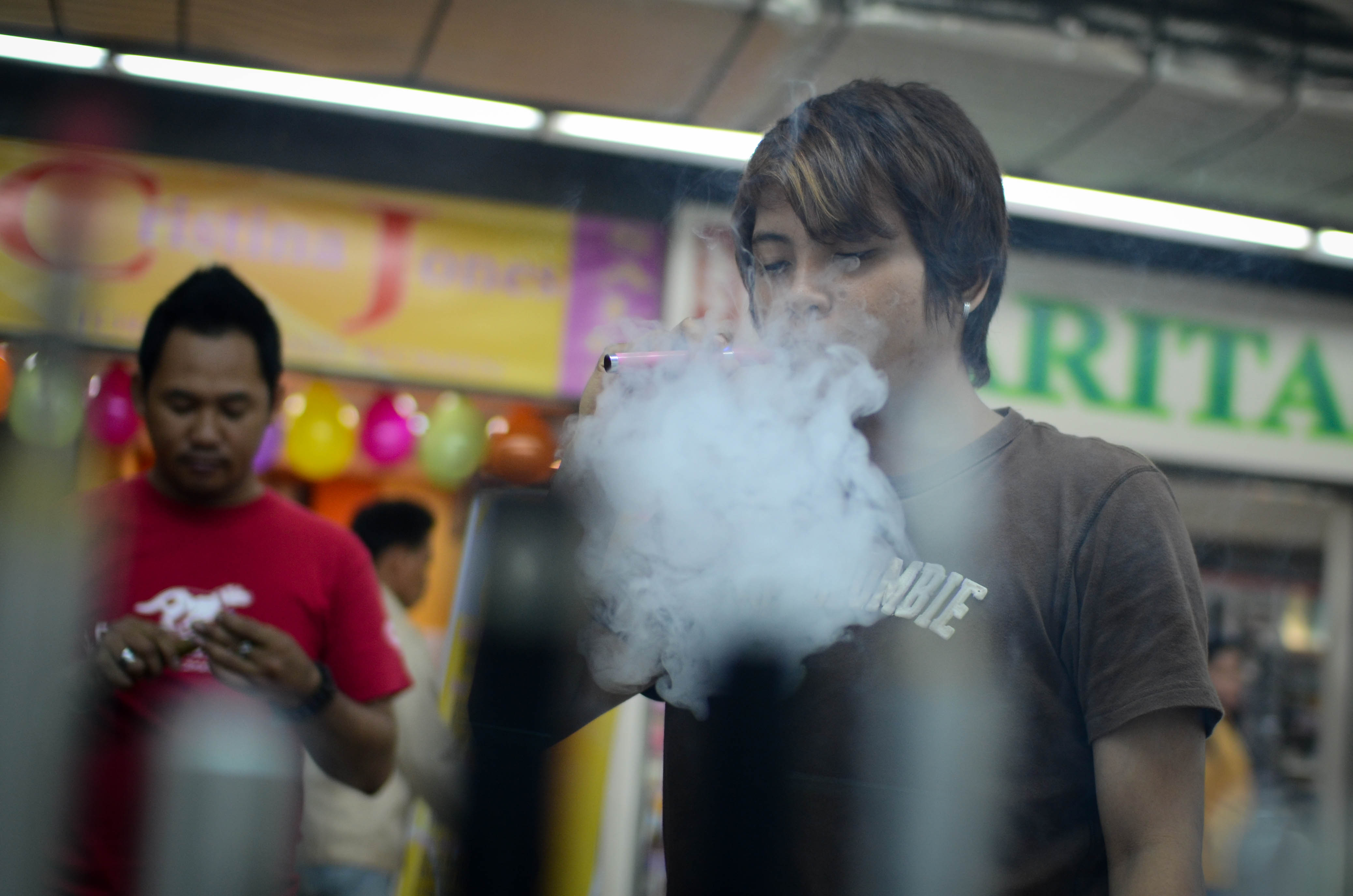 Consumers smoke electronic cigarettes at a mall on June 30, 2013 in Manila, Philippines. (Dondi Tawatao—Getty Images)