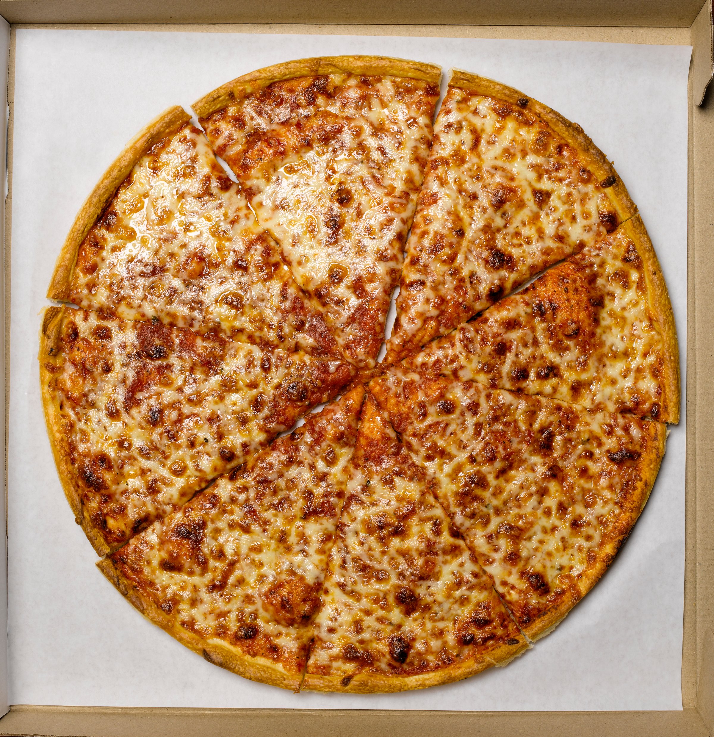 Whole pizza in box, overhead view