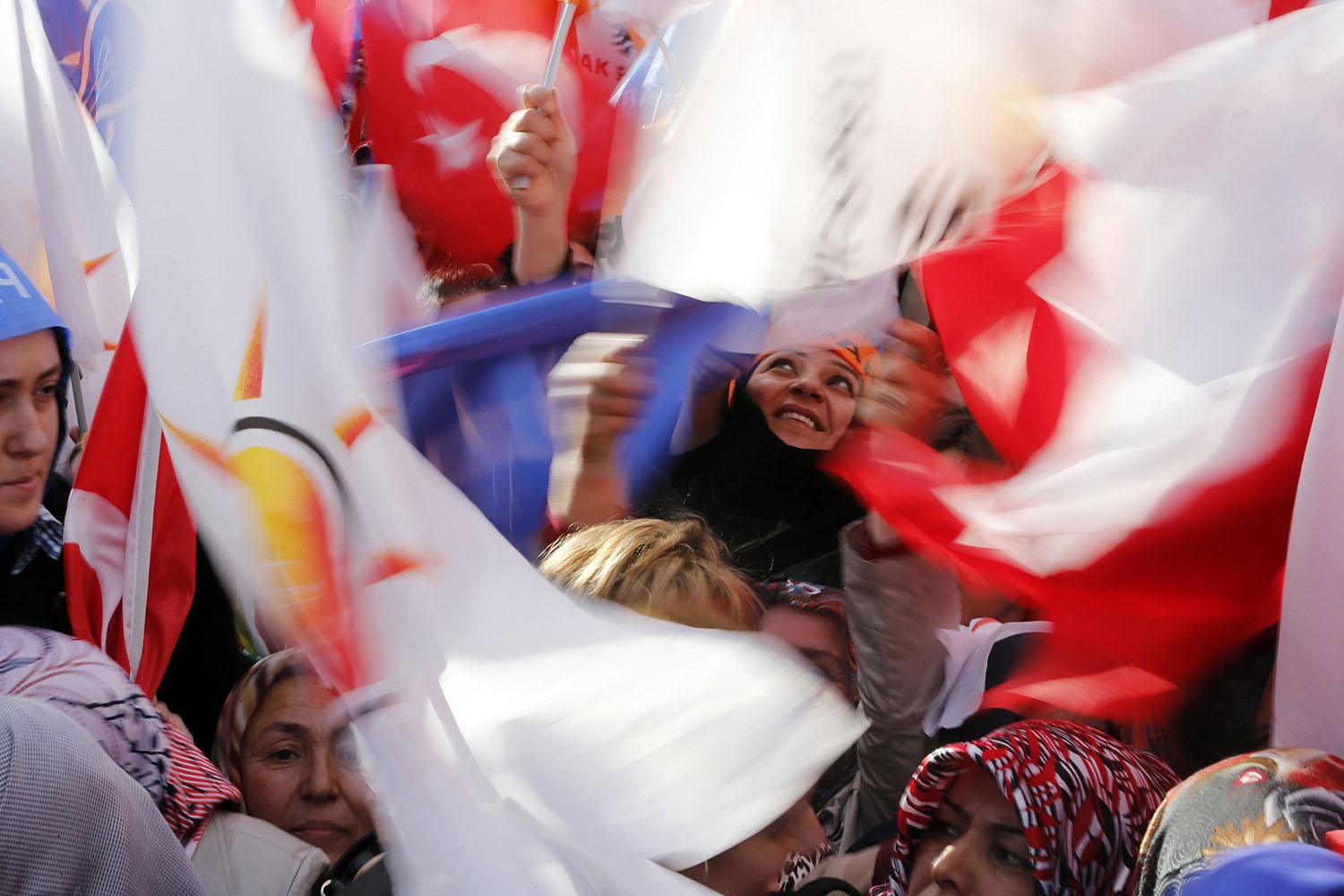 Supporters of ruling AK Party (AKP) wave party flags during an election rally in Kirikkale