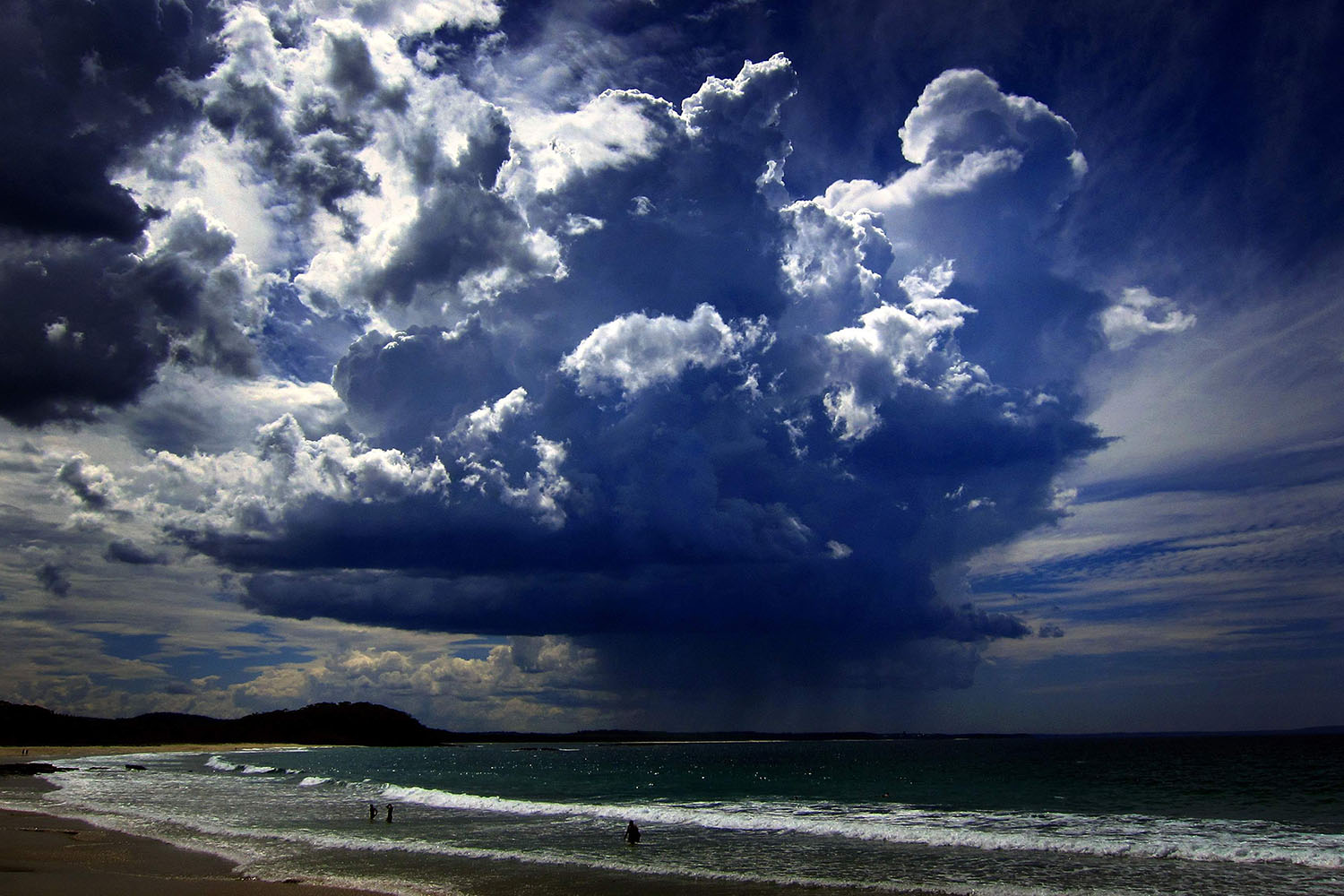 Mar. 5, 2014. A giant storm cloud can be seen in the sky above swimmers near Mollymook Beach, south of Sydney.