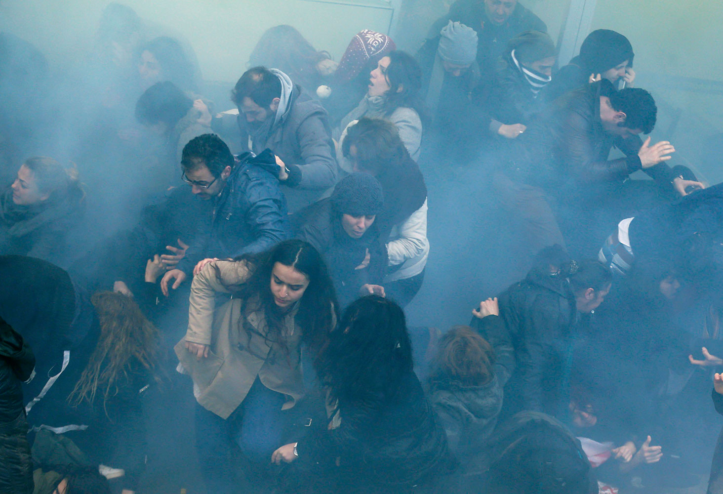Anti-government protesters run as police fires tear gas to push back thousands of demonstrators close to central Taksim square in Istanbul, March 12, 2014.