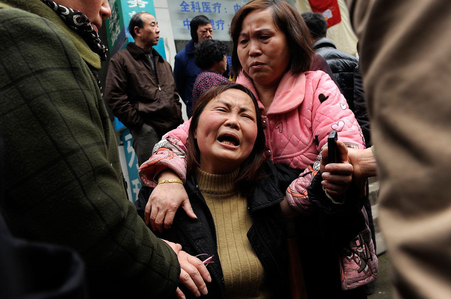 A woman cries after her parent was killed in a knifing incident in Changsha, Hunan province March 14, 2014.