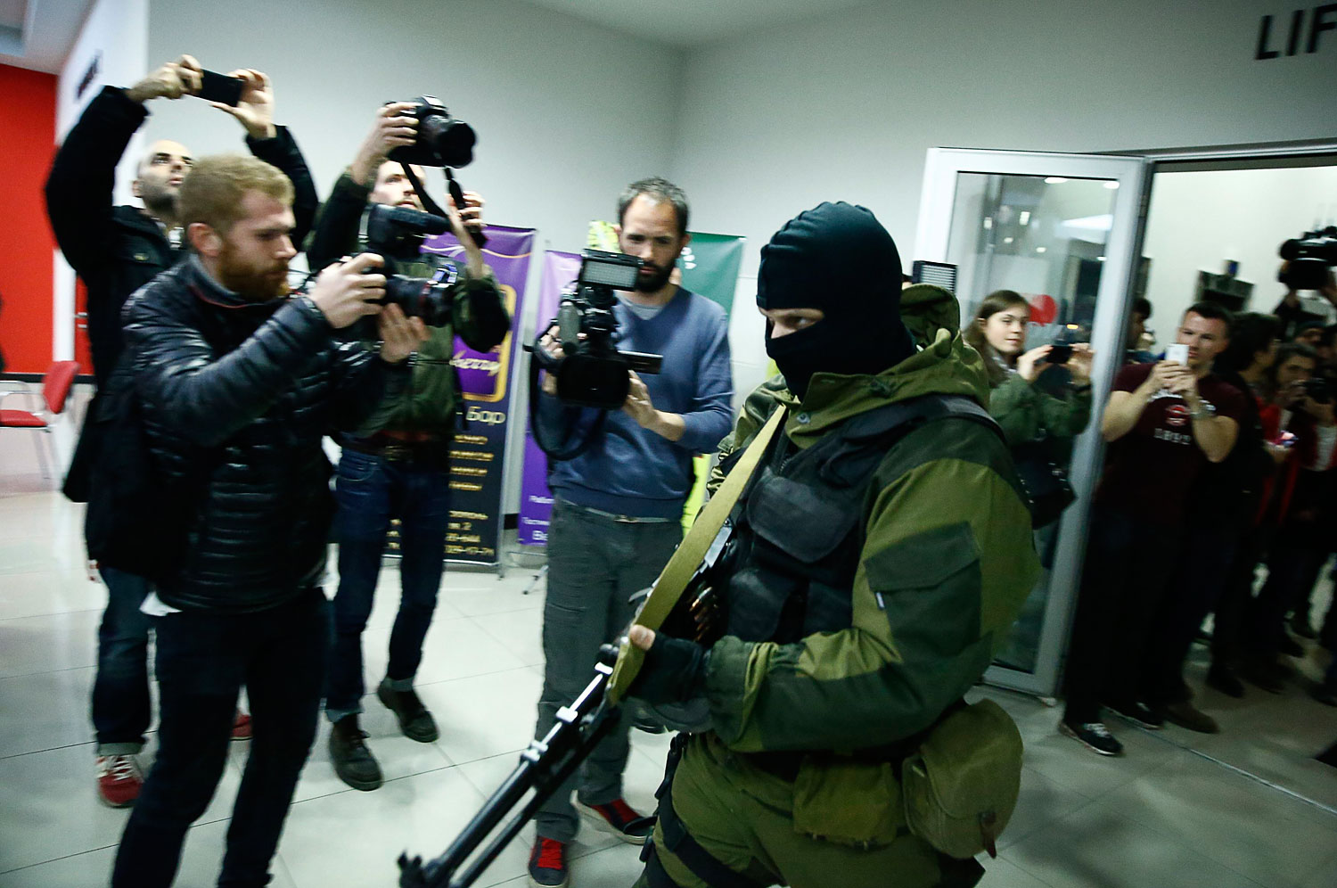An armed man leaves the Moscow hotel in Simferopol, March 15, 2014. (Thomas Peter—Reuters)