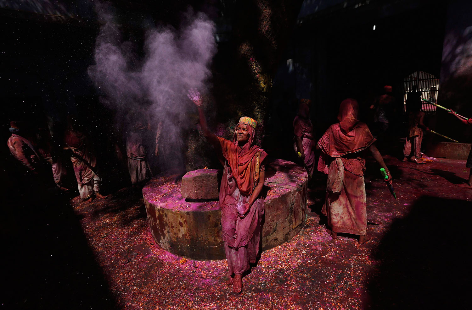 A widow throws coloured powder into the air during Holi celebrations organised by non-governmental organisation Sulabh International at a widows' ashram in Vrindavan in the northern Indian state of Uttar Pradesh, March 17, 2014.