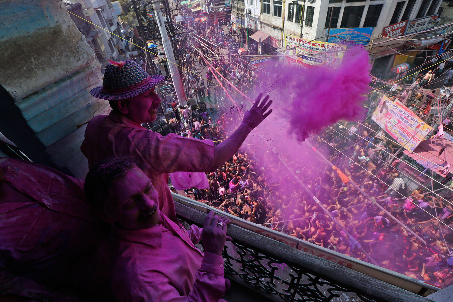 Indians throw colored powder and sprinkle water as they dance during celebrations marking Holi, the Hindu festival of colors, in Allahabad, India, March 17, 2014.