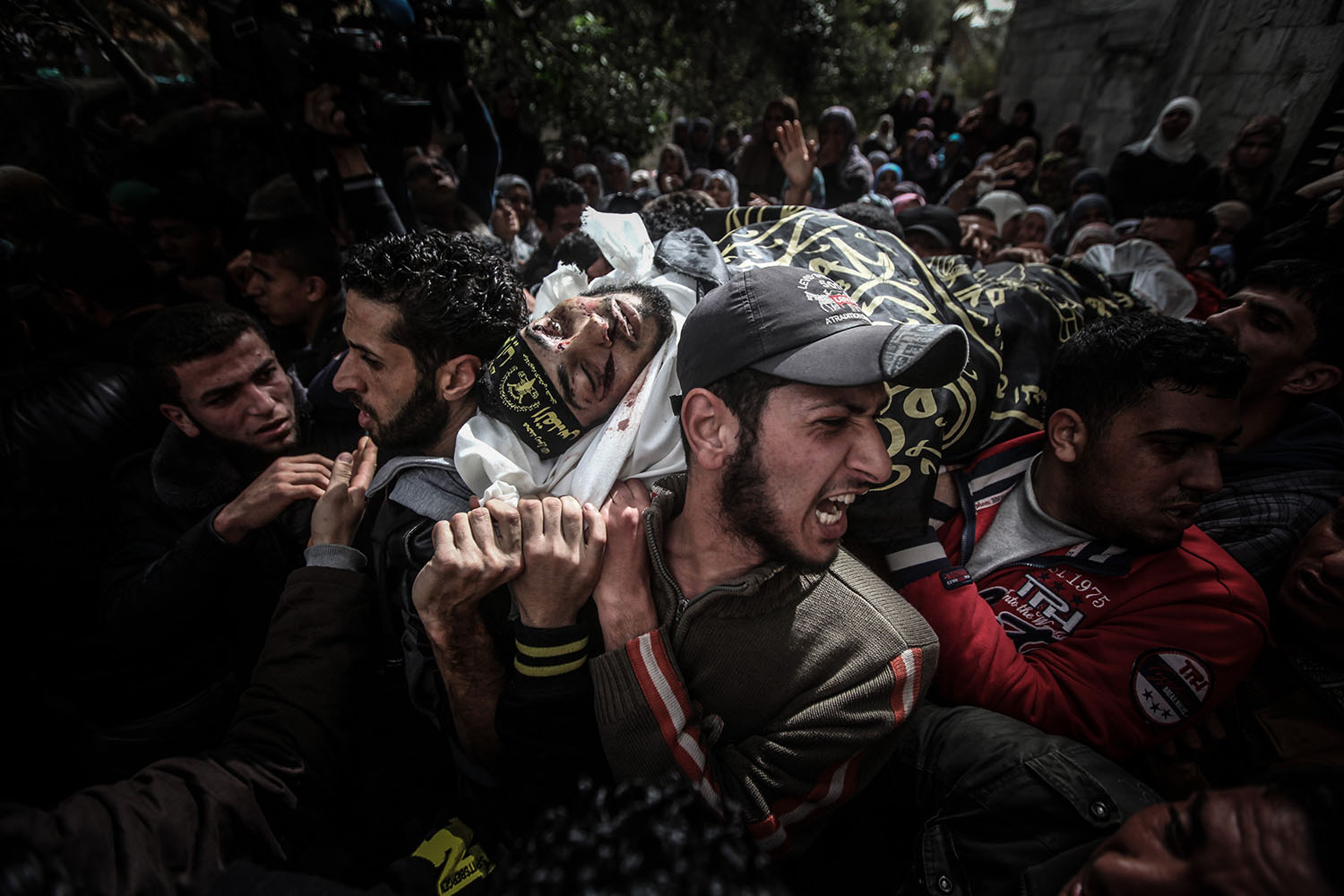 Mar. 4,  2014. Palestinians carry the body of Musab Za'anin, who was killed in an Israeli airstrike, during his funeral in Beit Hanoun in the northern Gaza Strip.