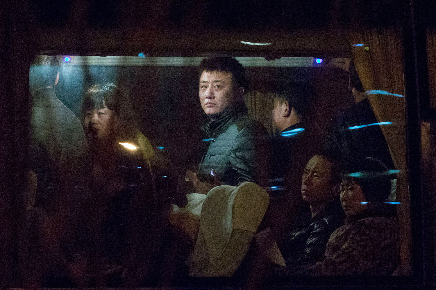 Relatives of Chinese passengers aboard a missing Malaysia Airlines plane wait on a bus in Beijing on March 9, 2014, to get paperwork to fly to Malaysia (Alexander F. Yuan—AP)