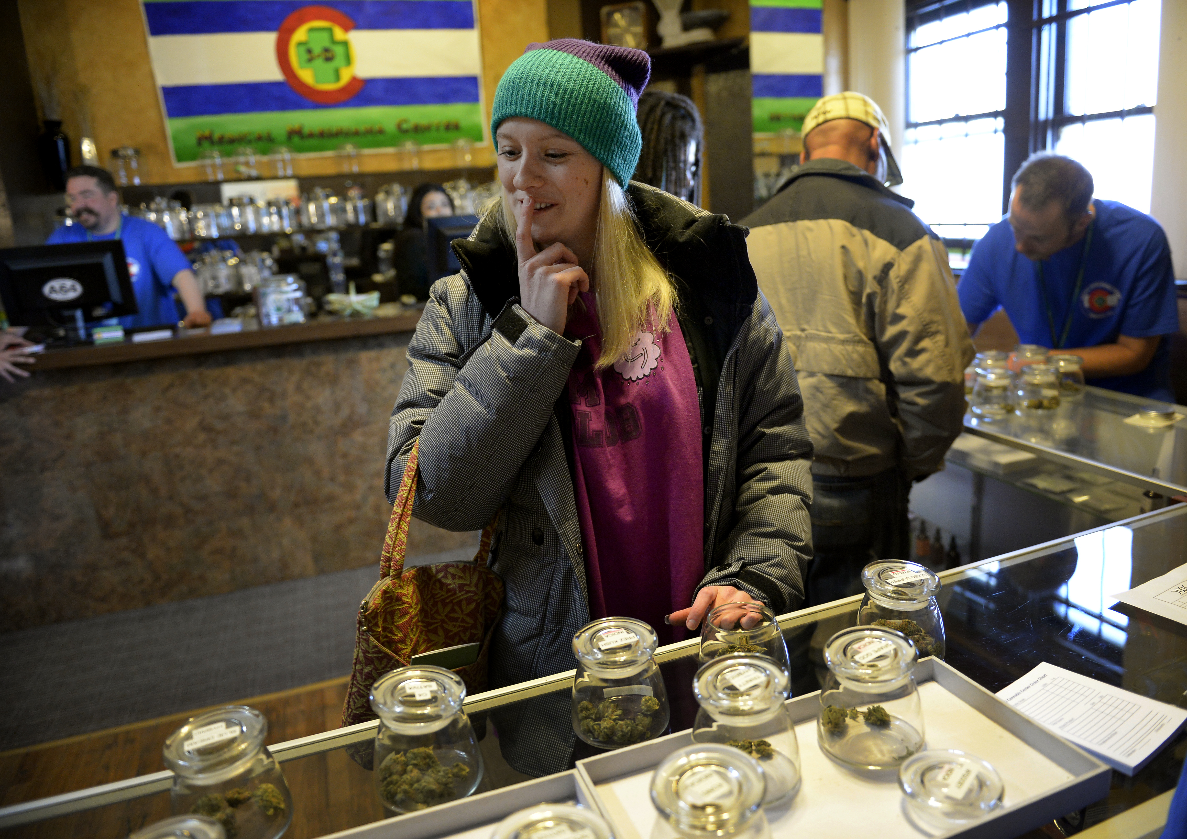 Kristin Brinckerhoff ponders the selection of marijuana  at 3D Cannabis Center in Denver, CO January 02, 2014. (Craig F. Walker—Denver Post/Getty Images)