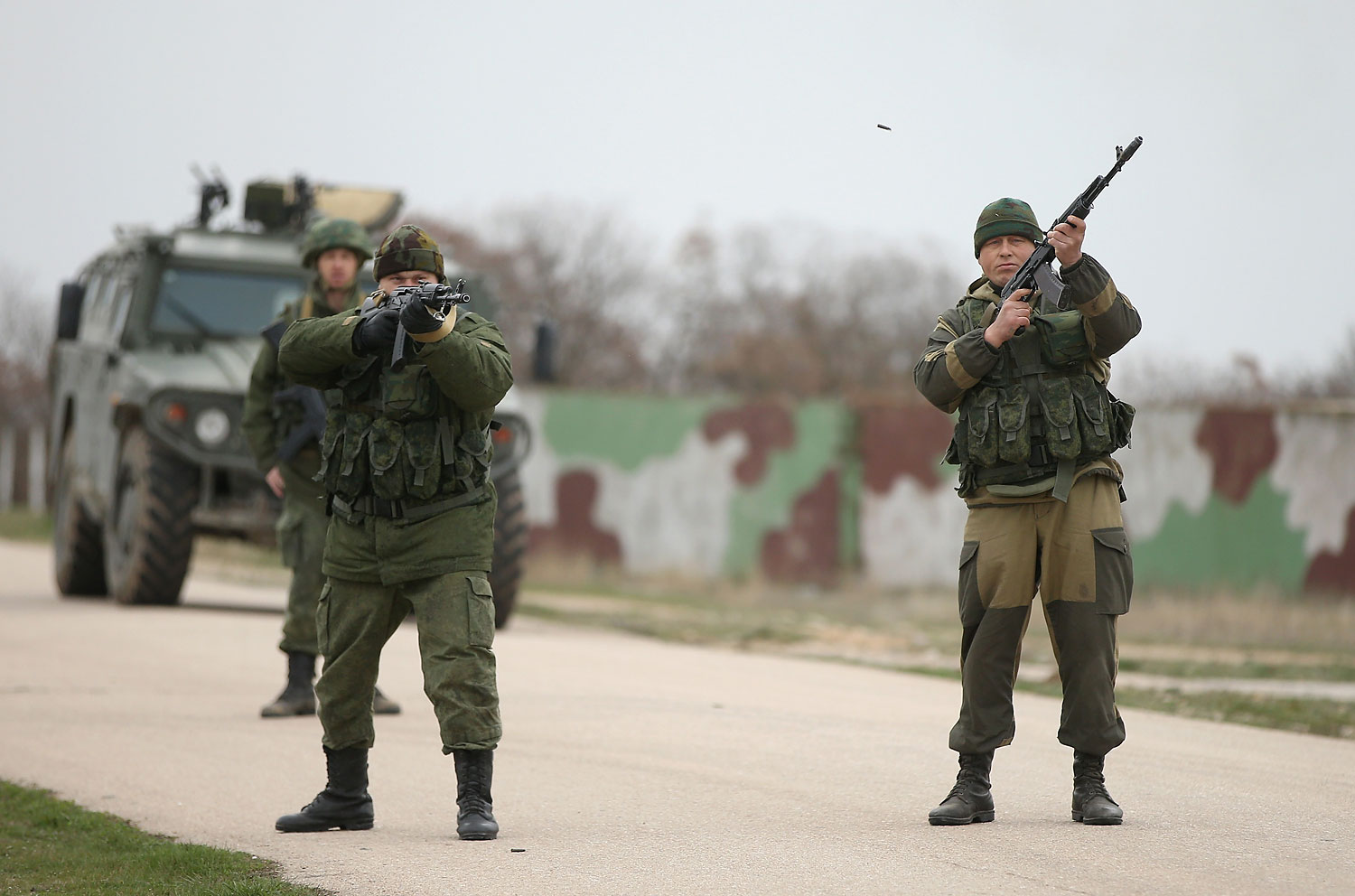 Troops under Russian command fire weapons into the air and scream orders to turn back at an approaching group of over 100 hundred unarmed Ukrainian troops at the Belbek airbase, which the Russian troops are occcupying, in Lubimovka, Crimea on March 4, 2014. (Sean Gallup—Getty Images)