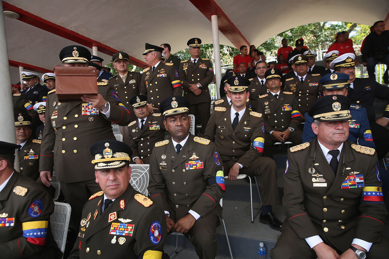 Venezuelan military officers watch an official parade marking the first anniversary of Hugo Chavez death on March 5, 2014 in Caracas.