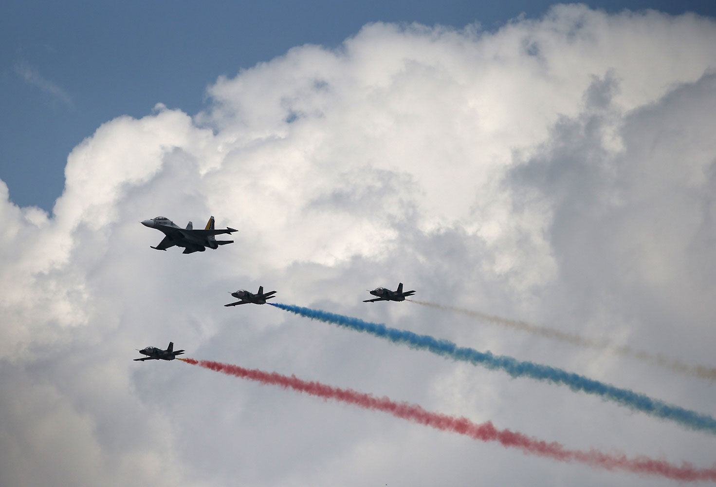 Venezuelan Air Force jets fly over an official parade marking the first anniversary of Hugo Chavez death on March 5, 2014 in Caracas, Venezuela.