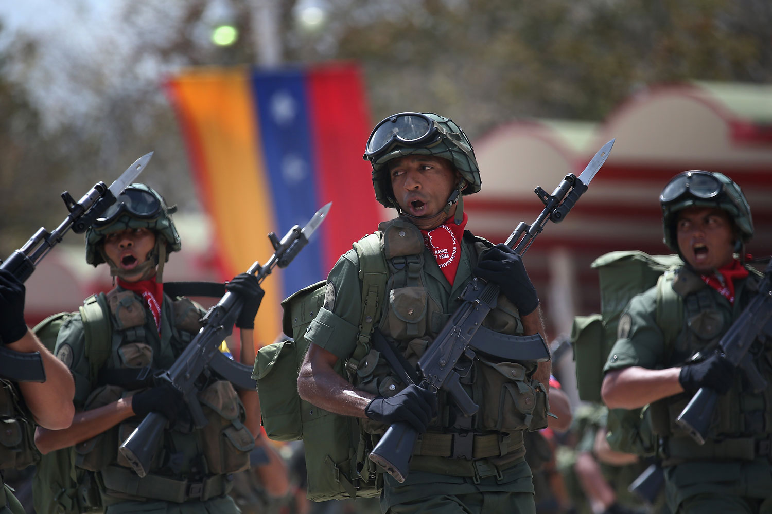 Venezuelan soldiers pass by dignitaries while marking the first anniversary of the death of Hugo Chavez on March 5, 2014 in Caracas.