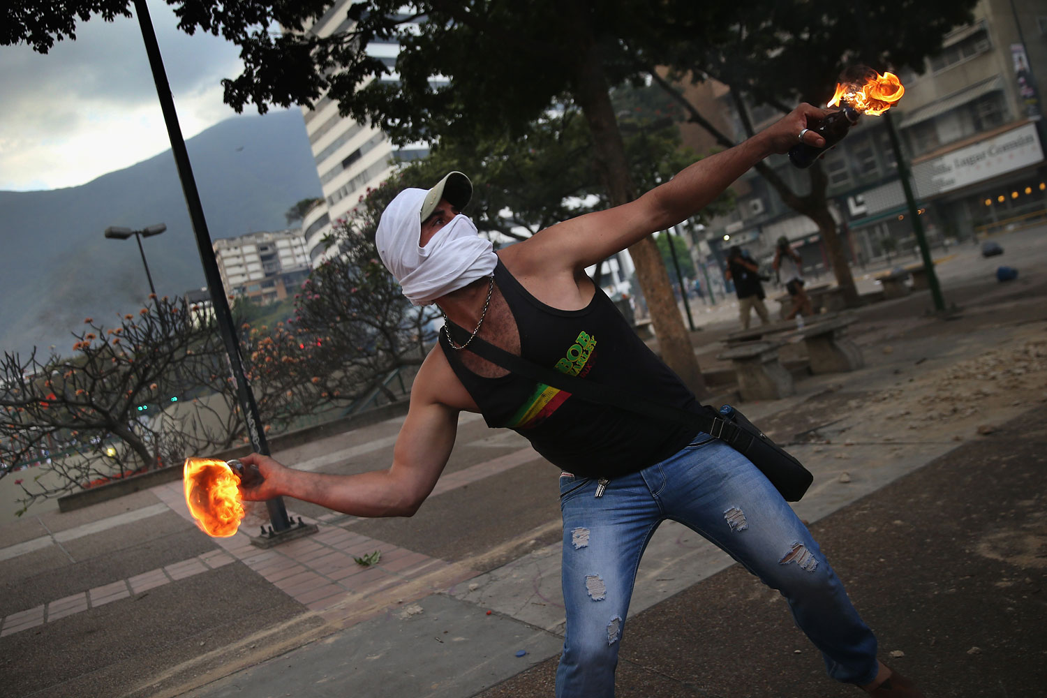 A protester throws a molotov cocktail at Venezuelan security forces during an anti-government demonstration on March 6, 2014 in Caracas.