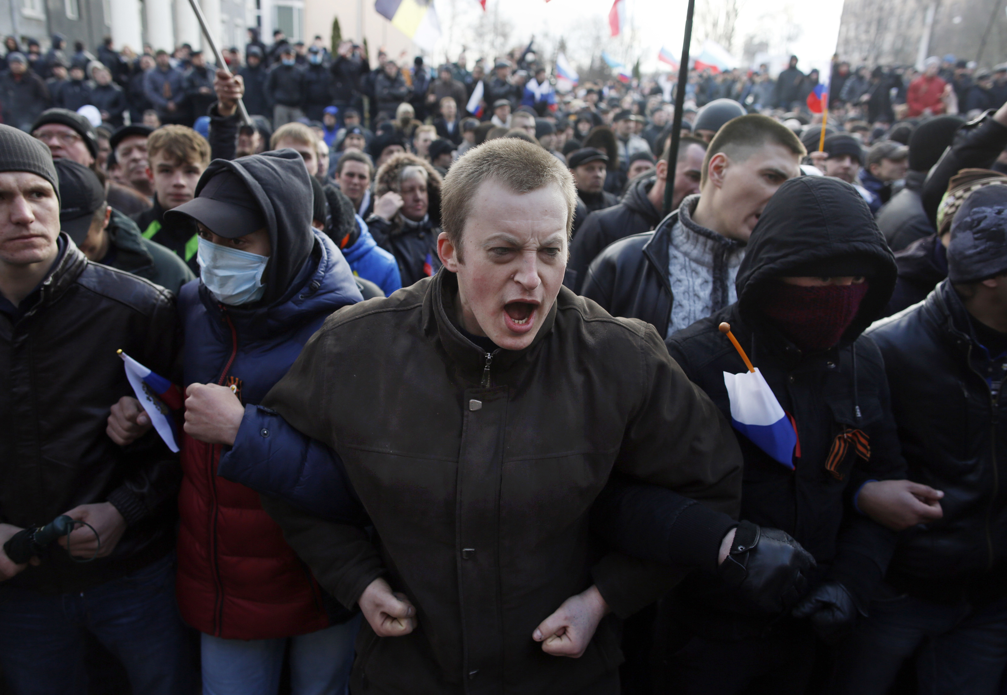 DONETSK, UKRAINE - MARCH 16: Pro-Russian protesters chant outside of the Donetsk Prosecutors Building before storming into the building during a protest in Donetsk, Ukraine on March 15, 2014. (Photo by Jessica Rinaldi for The Boston Globe via Getty Images)