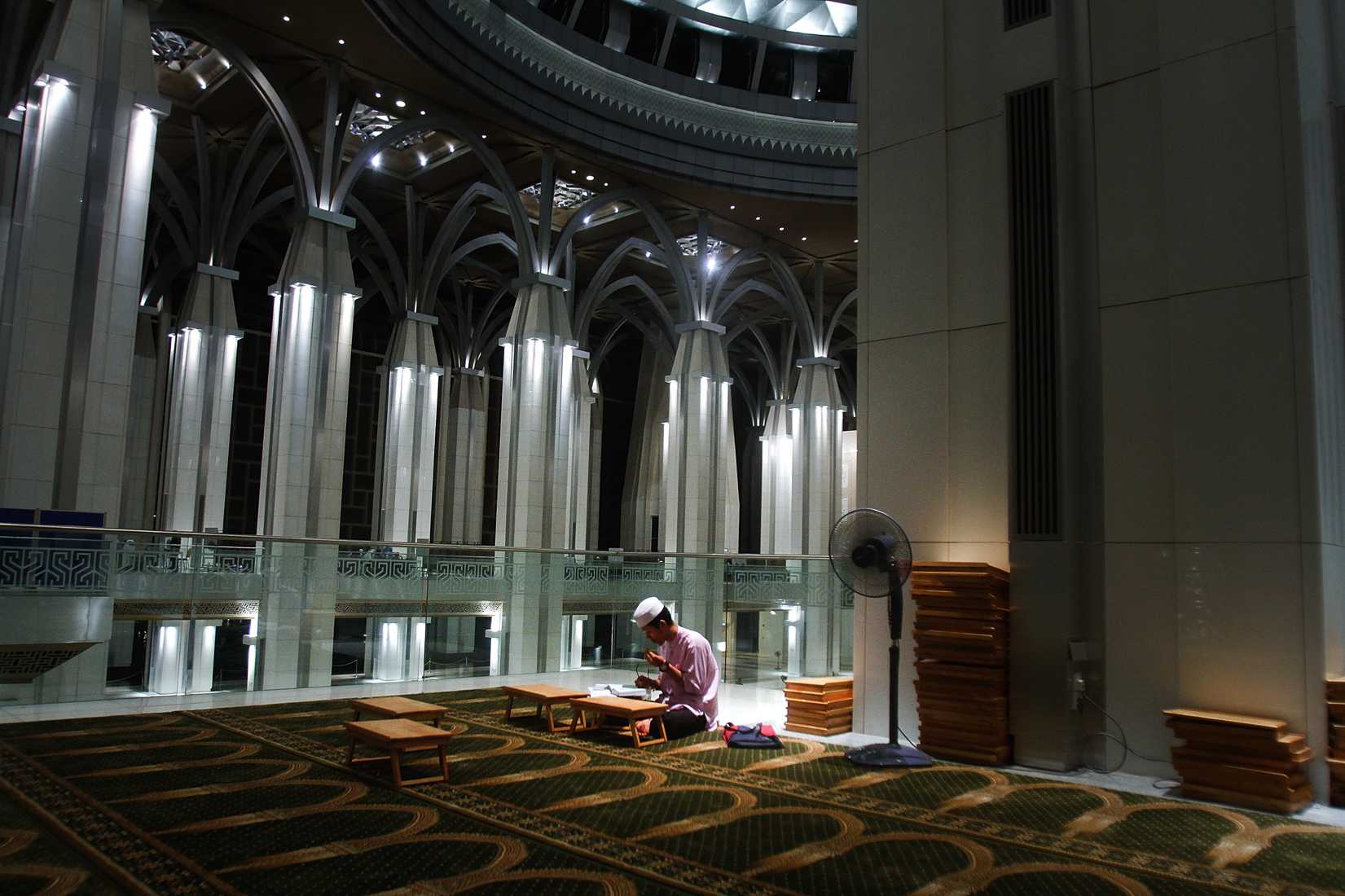 A man recites the Koran after a special prayers held for the missing Malaysian airliner MH370, March 18, 2014 in Kuala Lumpur, Malaysia. (Rahman Roslan—Getty Images)