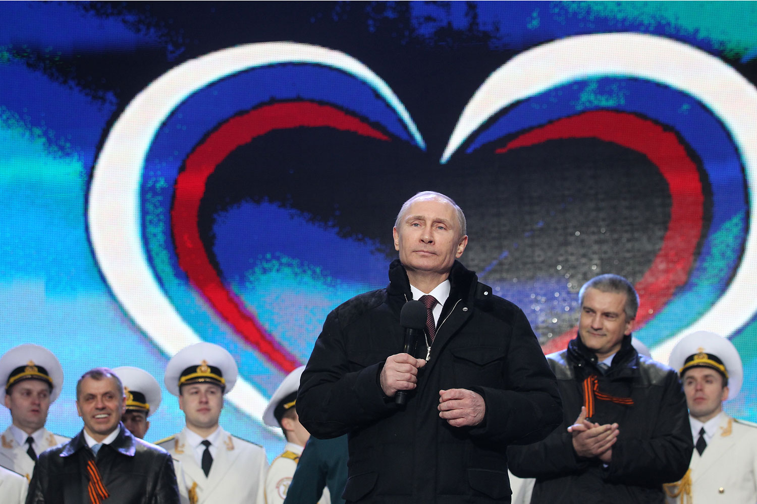 Russian President Vladimir Putin and Crimean Prime Minister Sergei Aksyonov attend a rally at Red Square on March 18, 2014 in Moscow.